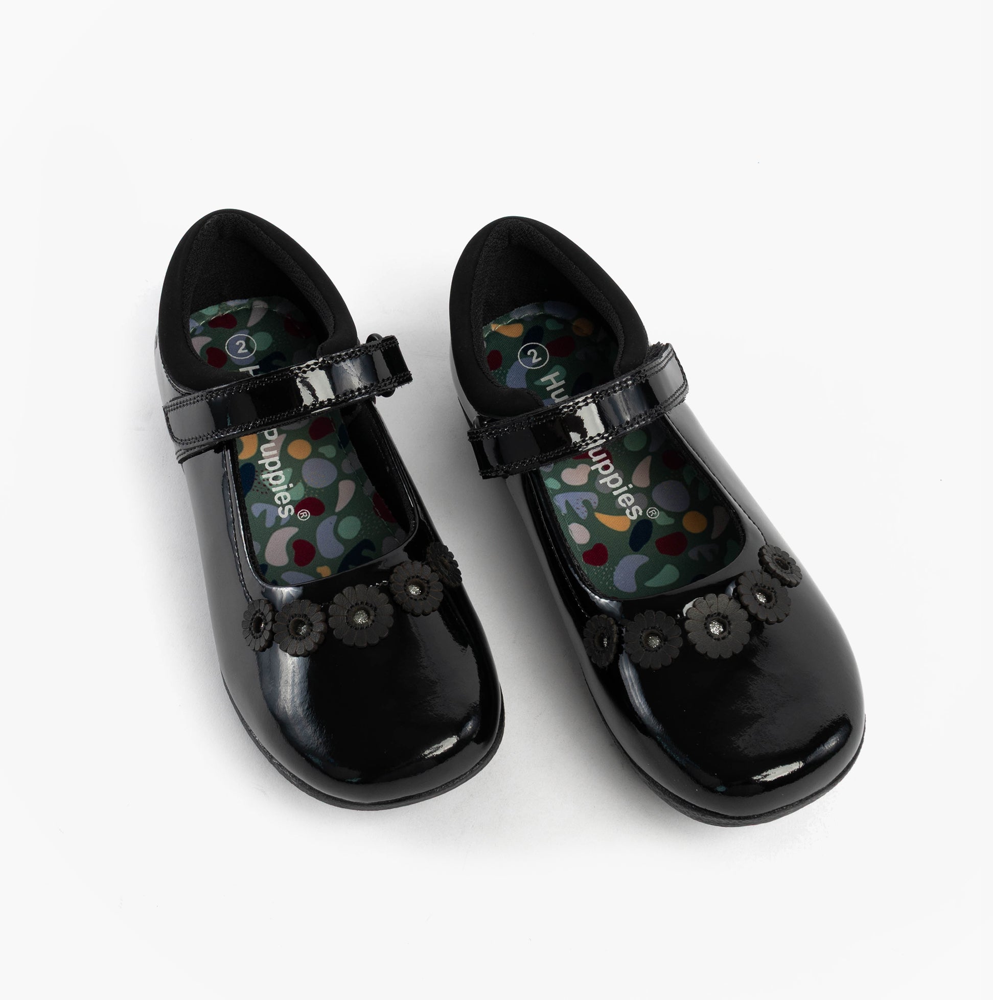 Hush Puppies CHRISTINA PATENT JUNIOR Girls Shoes Black side view showing patent leather upper and floral embellishments.