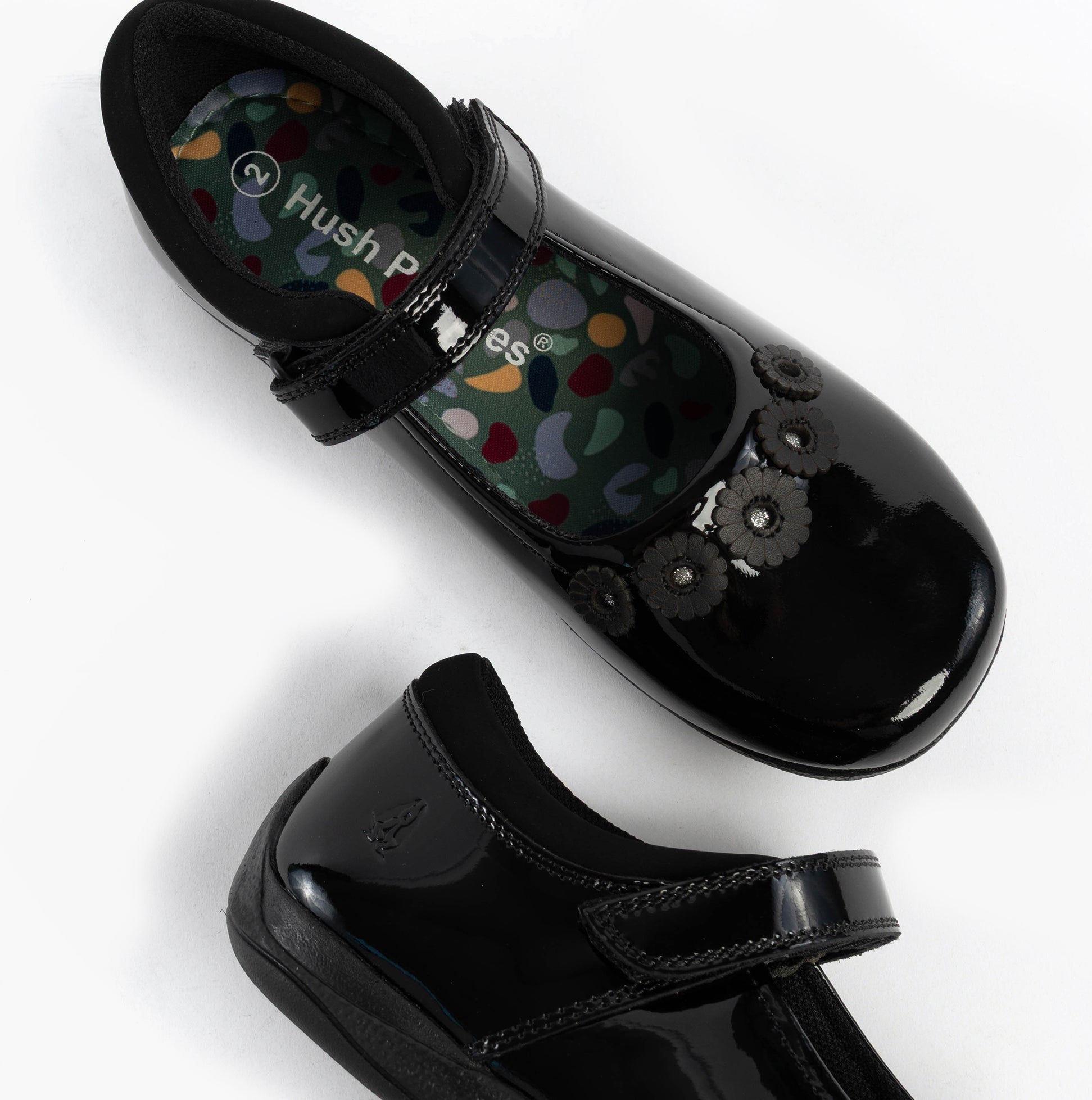 Hush Puppies CHRISTINA PATENT JUNIOR Girls Shoes Black, top view showcasing patent leather and floral design.