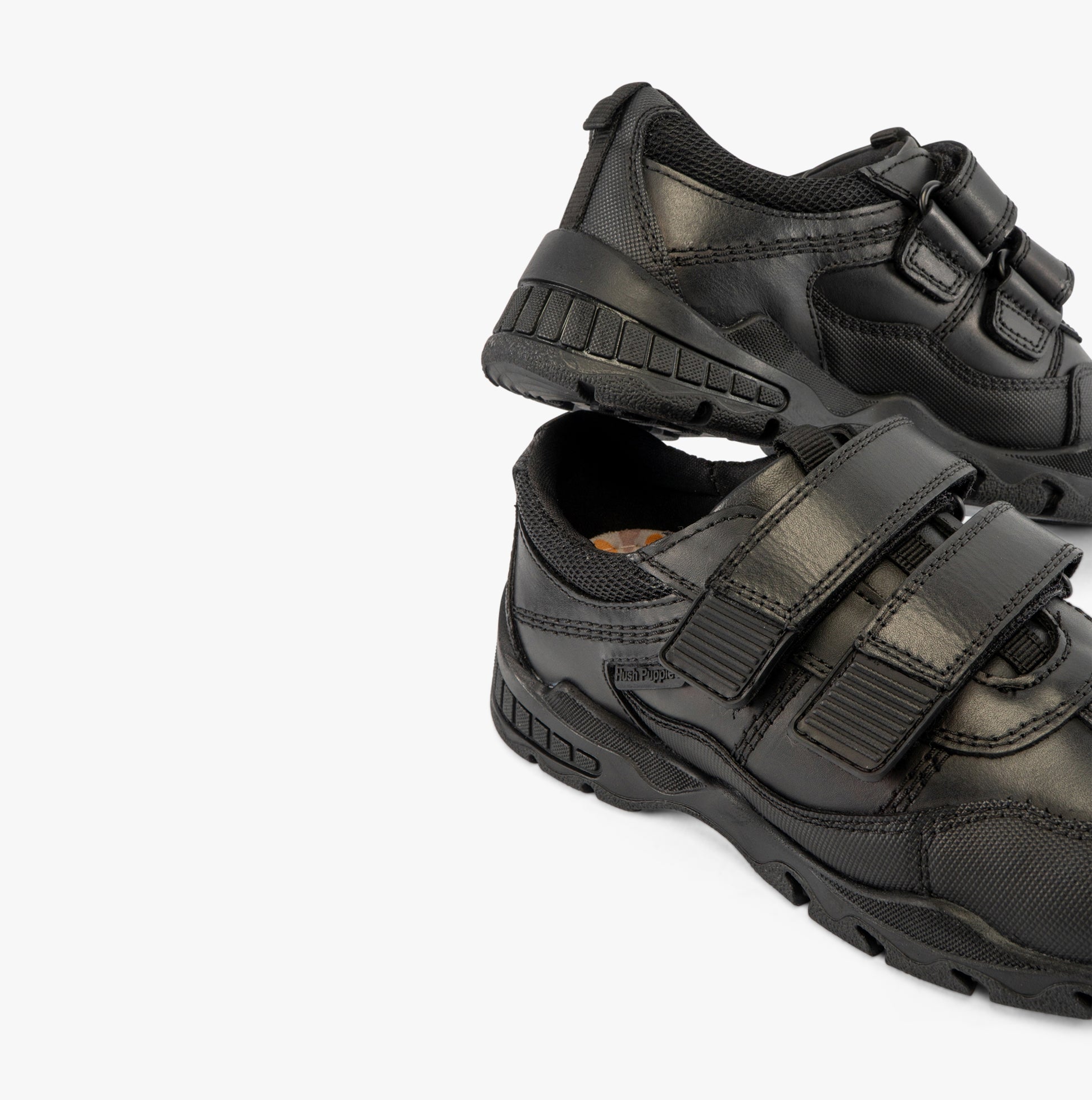 Hush Puppies TROY Boys School Shoes Black side view featuring black leather upper, touch fasten straps and low top design.