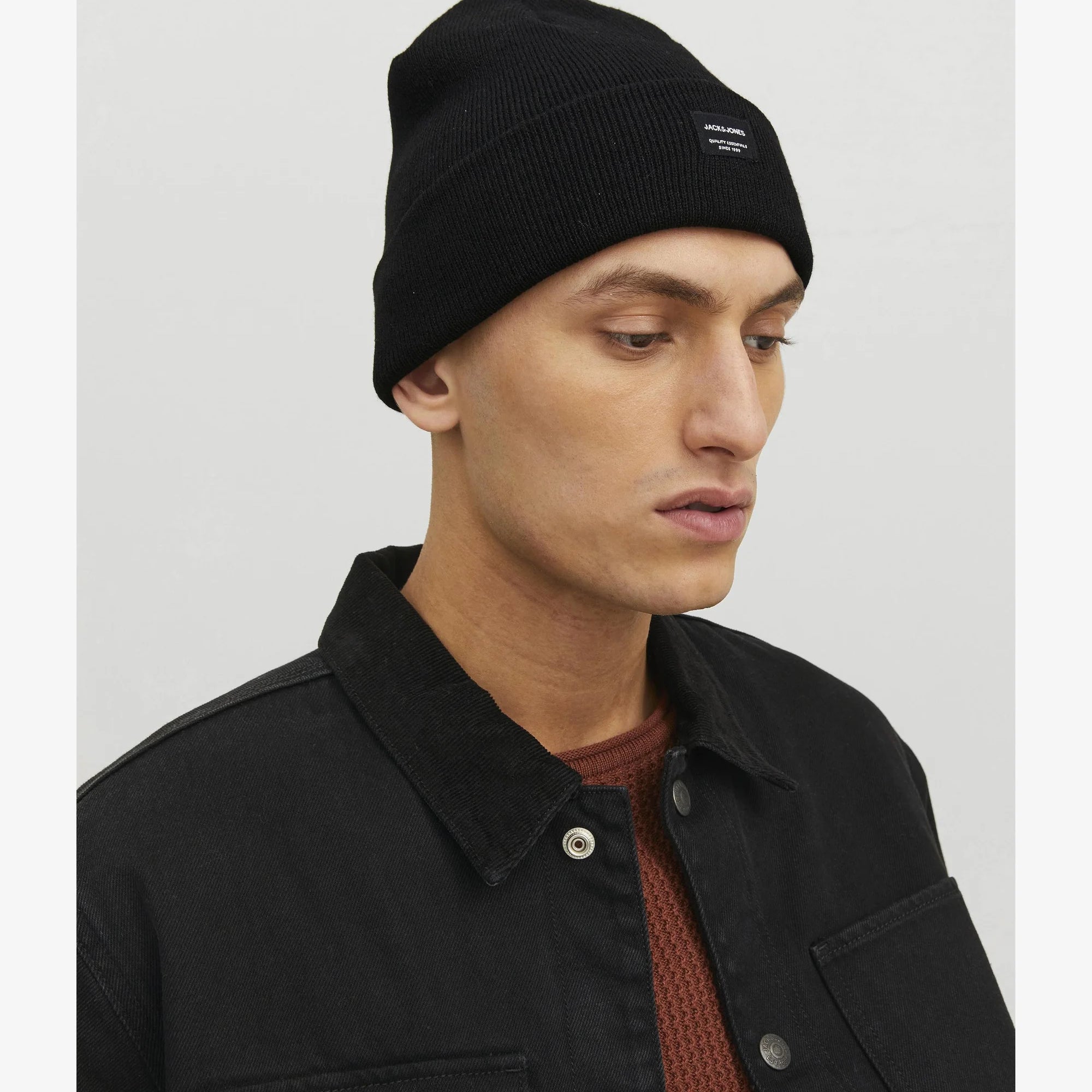 Jack & Jones DNA Mens Beanie Black worn by model in side view with black jacket.