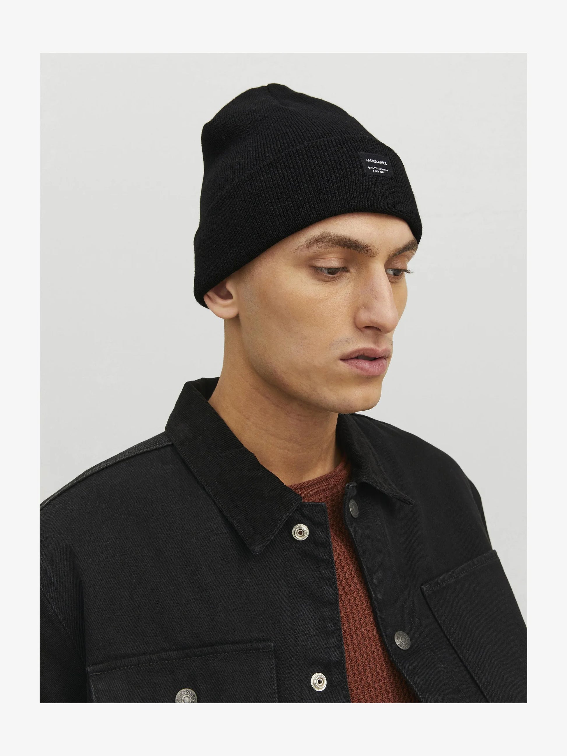 Jack & Jones DNA Mens Beanie Black worn by model in side view with black jacket.
