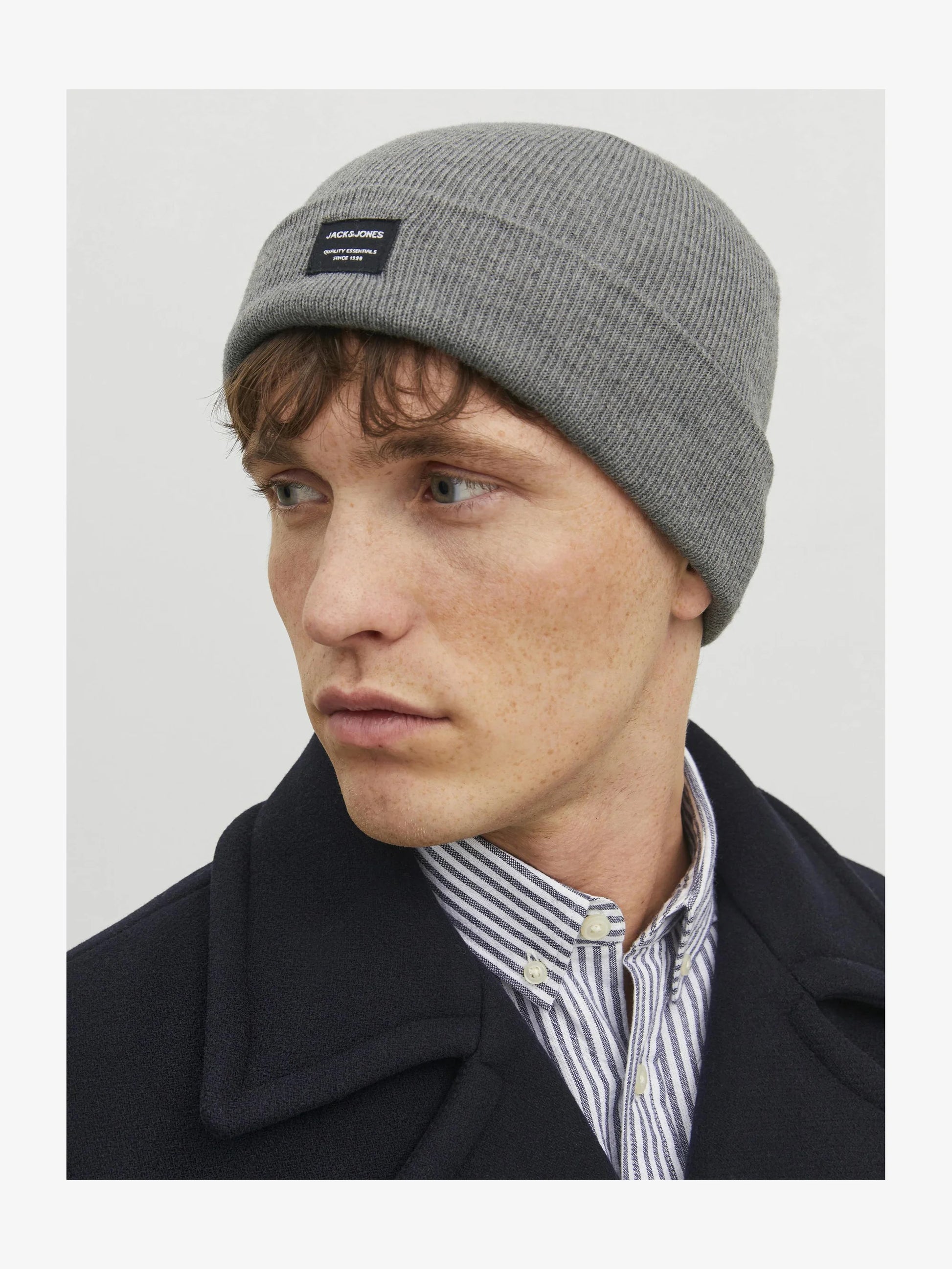 Jack & Jones DNA Mens Beanie Grey Melange worn by a model in profile view, showcasing its comfortable fit and stylish design.