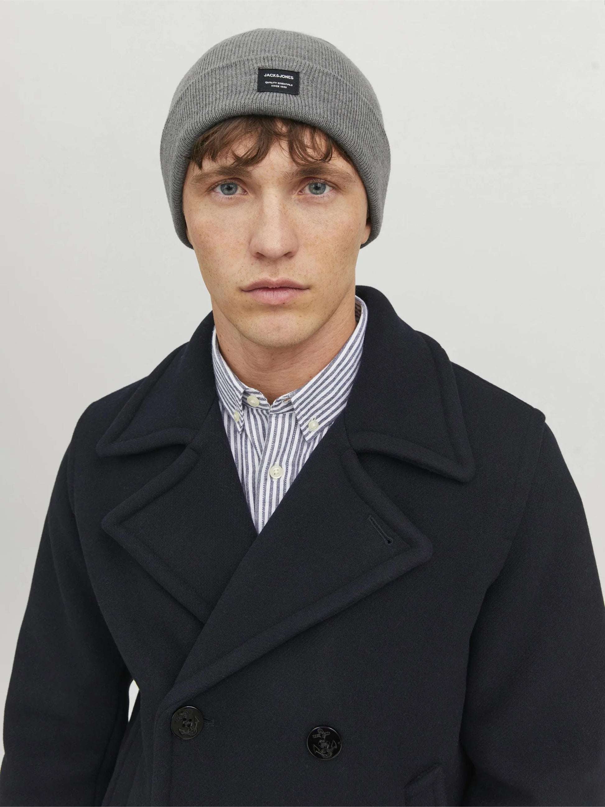 Jack & Jones DNA Mens Beanie Grey Melange front view on model wearing a navy coat and striped shirt.