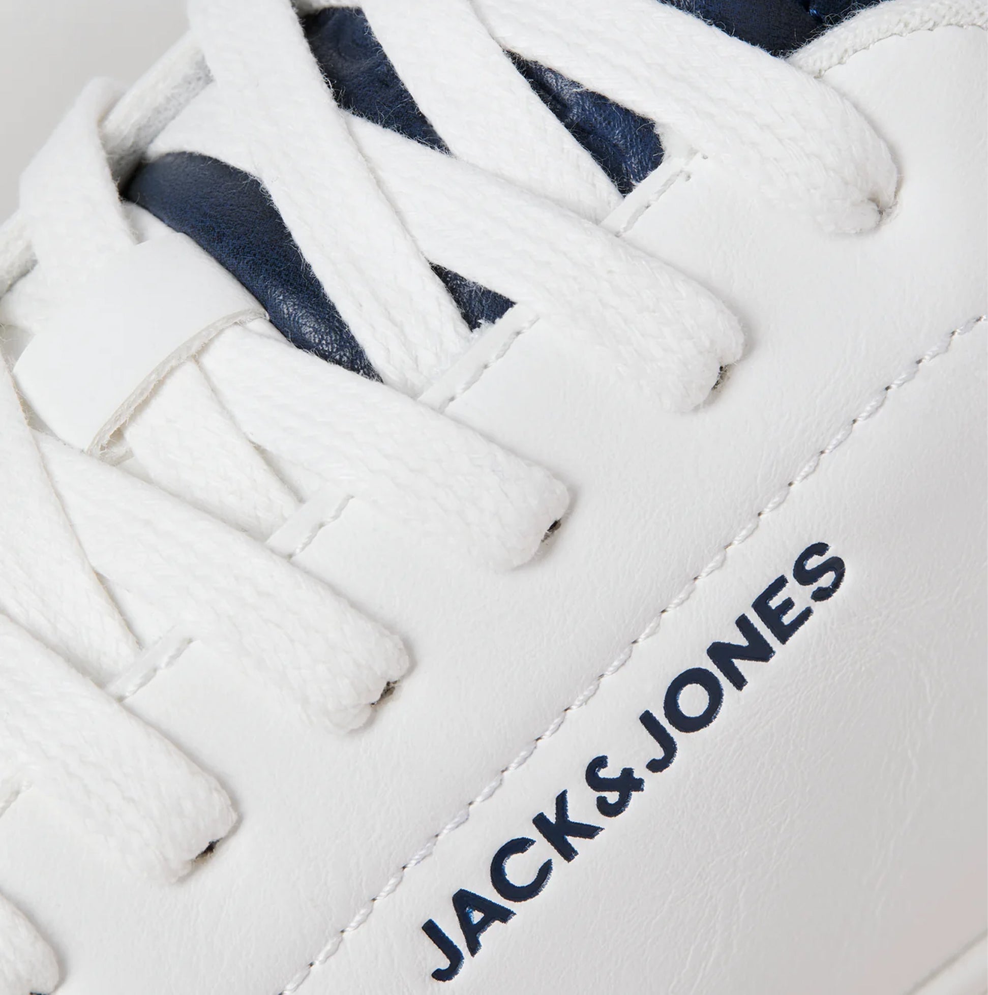 Detail view of Jack & Jones BOSLEY PU Mens Trainers White showing lace and logo design.