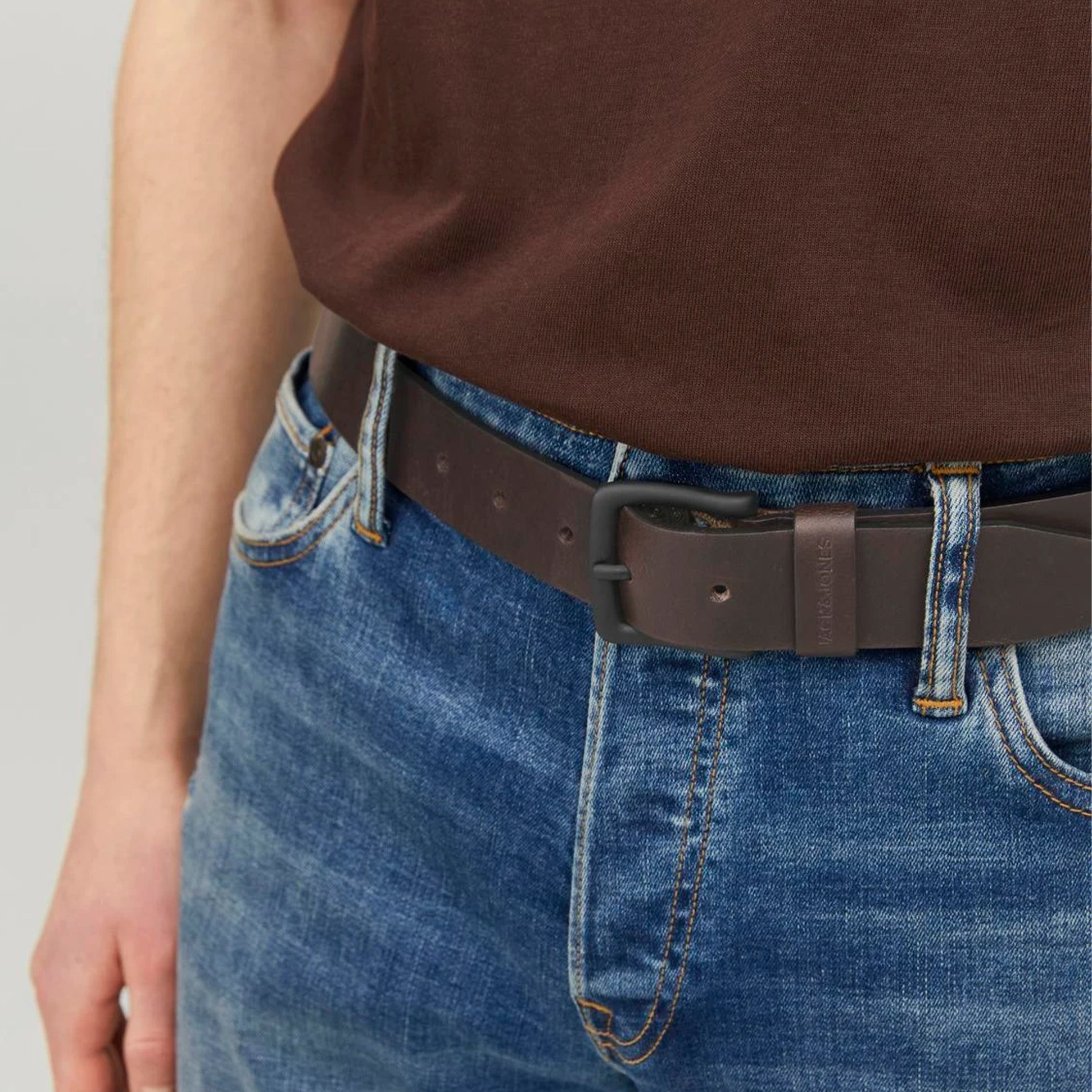 Jack & Jones ROMA Mens Belt Brown Coffee detail view showing belt worn with blue jeans and brown shirt.