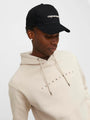 Jack & Jones VESTERBRO Mens Cap Black front view worn by model with light hoodie.
