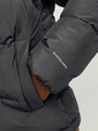 Jack & Jones WORLD Mens Puffer Jacket Asphalt detail view showcasing the arm and brand logo on a dark gray puffer fabric.