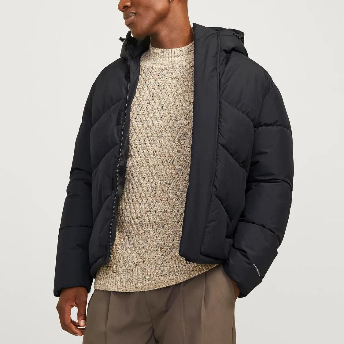 Jack & Jones WORLD Mens Puffer Jacket Black front view on model with adjustable hood and warm padding.