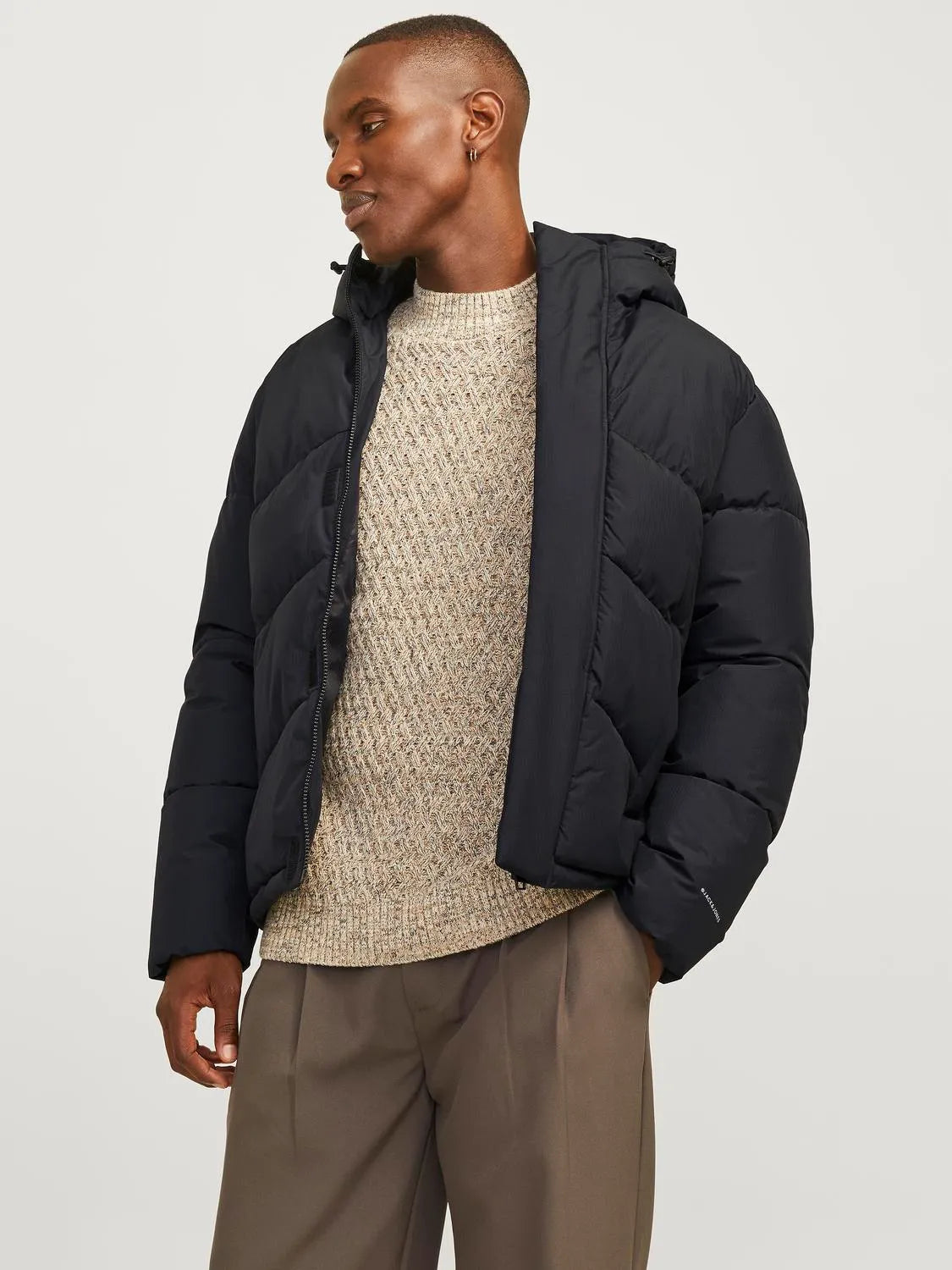 Jack & Jones WORLD Mens Puffer Jacket Black front view on model with adjustable hood and warm padding.