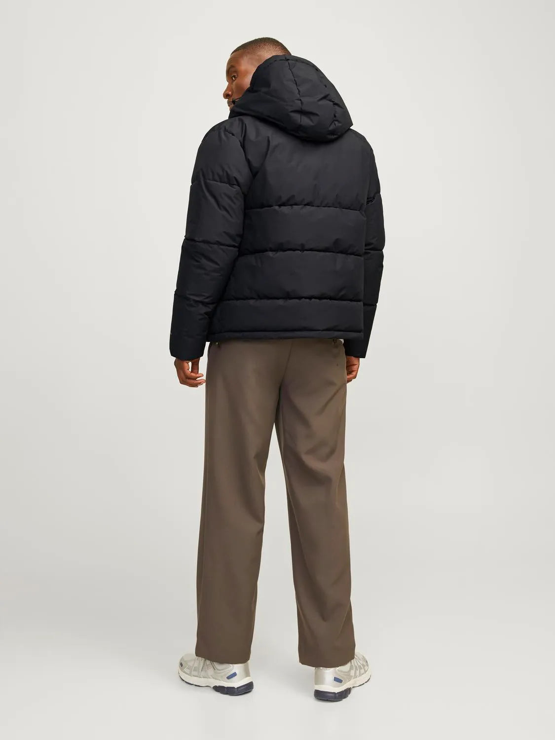 Jack & Jones WORLD Mens Puffer Jacket Black back view on model wearing light brown trousers.