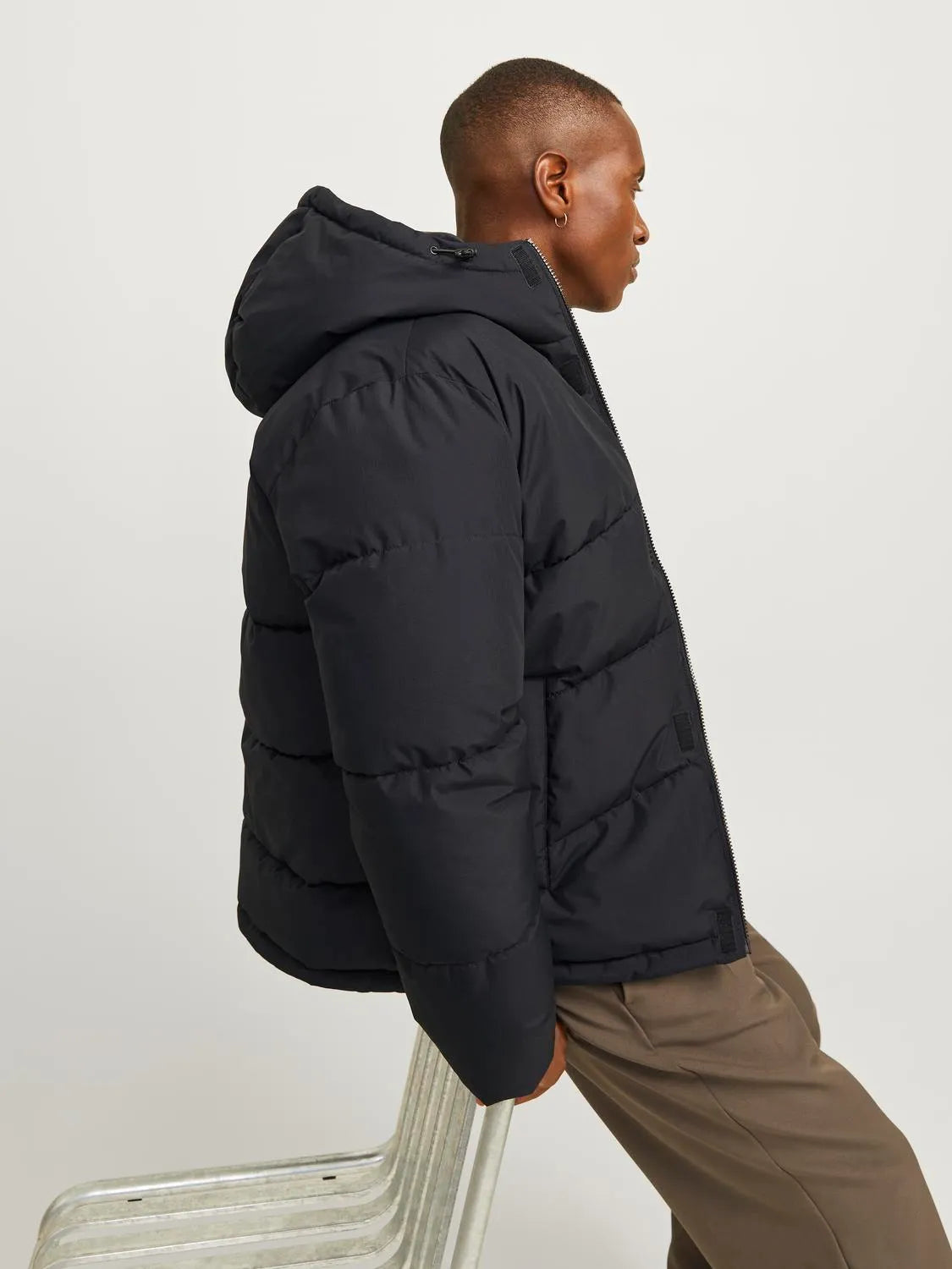 Jack & Jones WORLD Mens Puffer Jacket Black side view showcasing adjustable hood and puffy design.