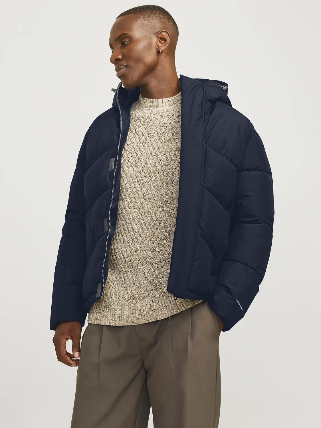 Jack & Jones WORLD Mens Puffer Jacket Navy Blazer front view worn by a model, showcasing its stylish design and hood.