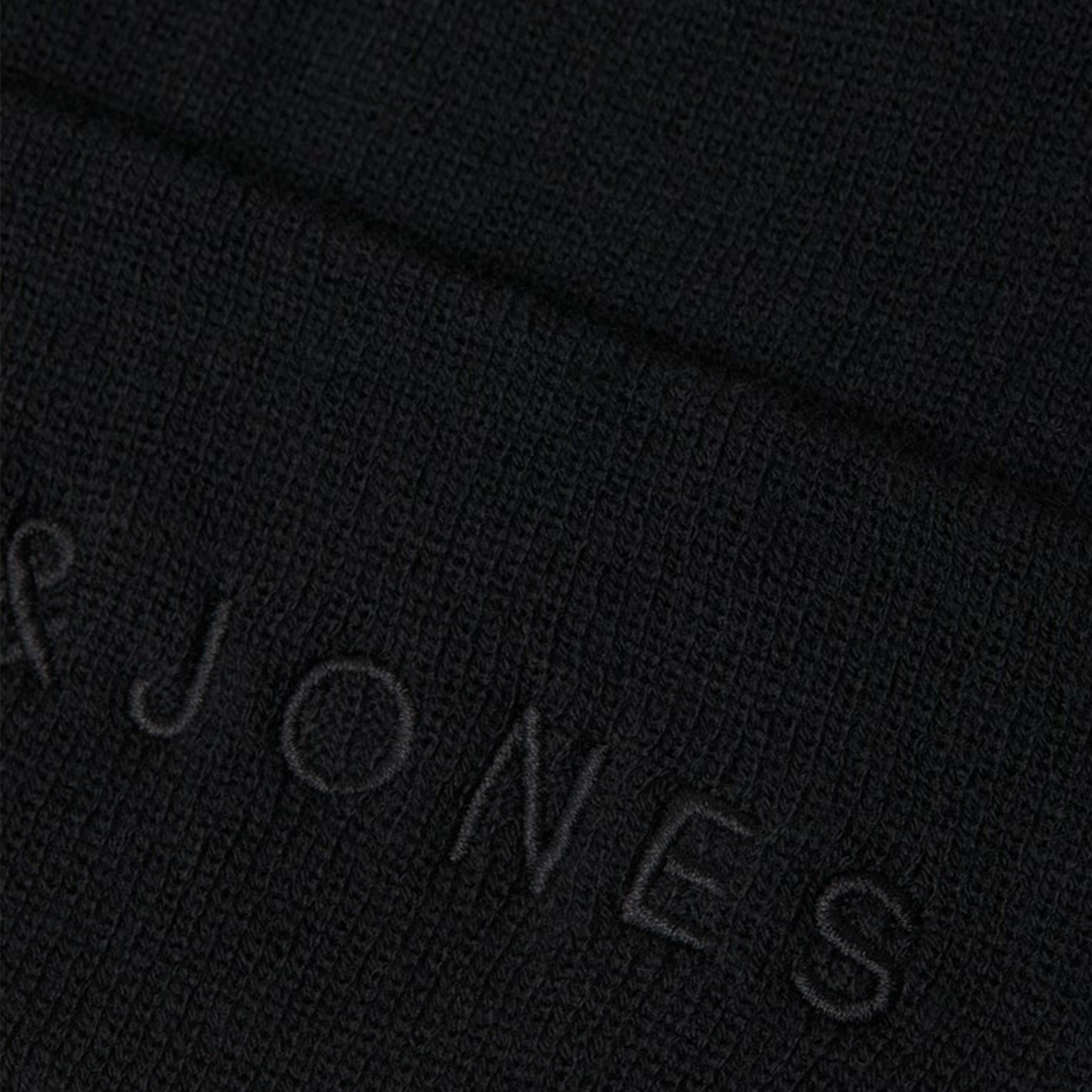 Jack & Jones GIVE Mens Beanie Black detail view showing textured black fabric and embroidered brand logo.