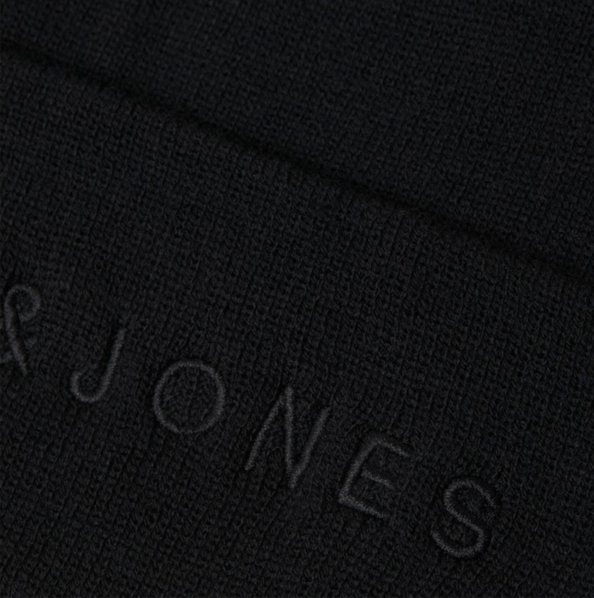 Jack & Jones GIVE Mens Beanie Black detail view showing textured black fabric and embroidered brand logo.