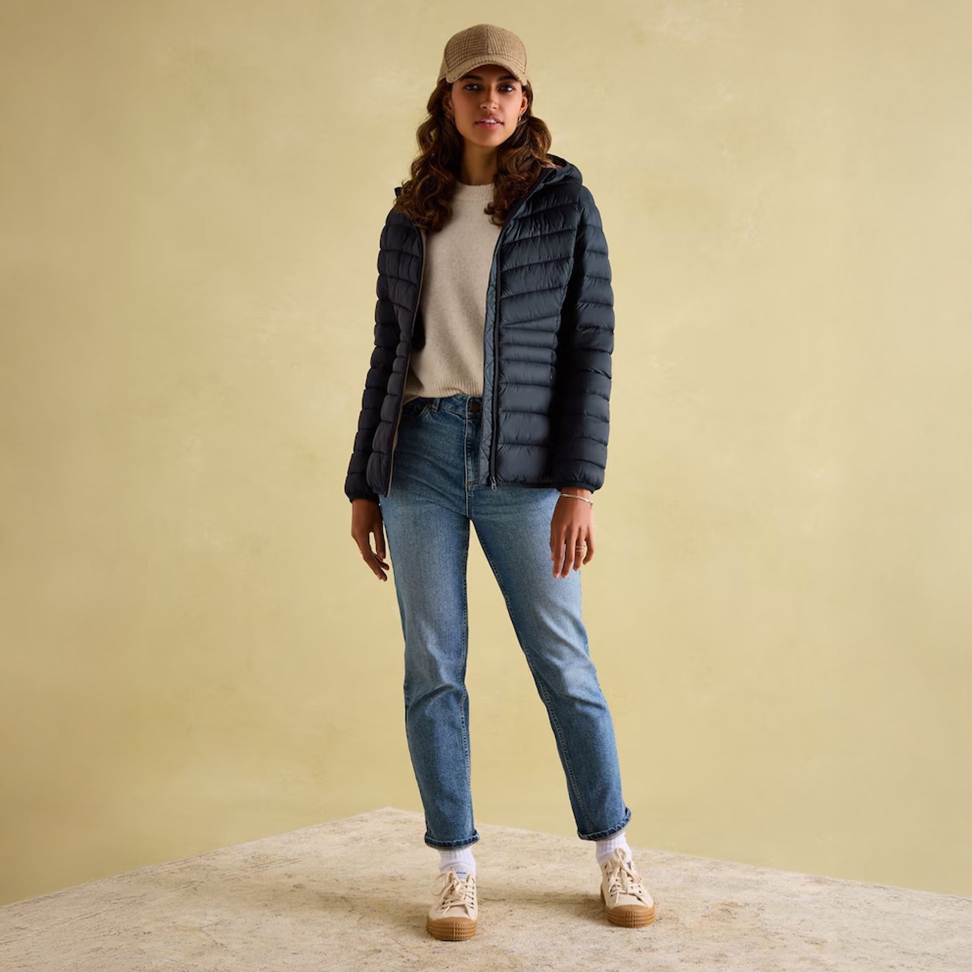 Joules KENLEY Womens Showerproof Hooded Puffer Jacket Navy front view worn with jeans and a sweater.