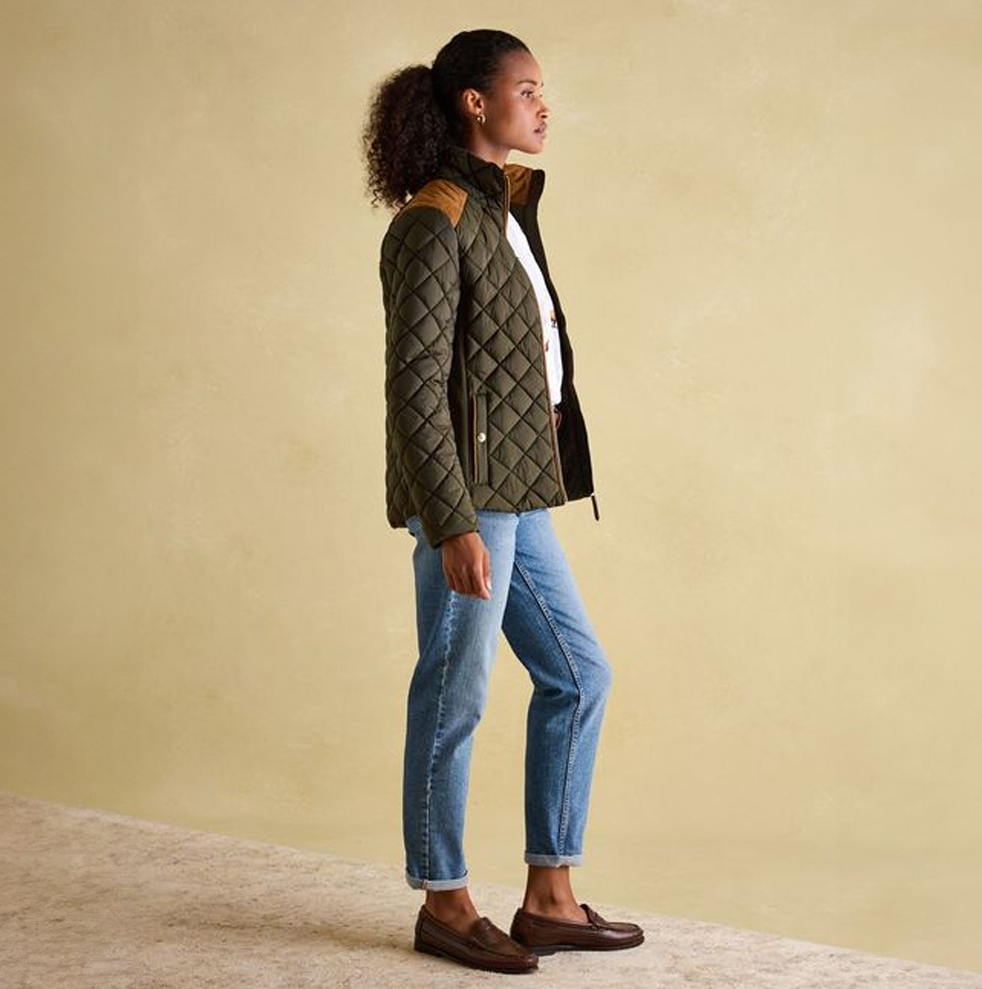 Joules BRAEMAR LUXE Womens Quilted Jacket Green side view on model, featuring diamond quilted design and suede shoulders.