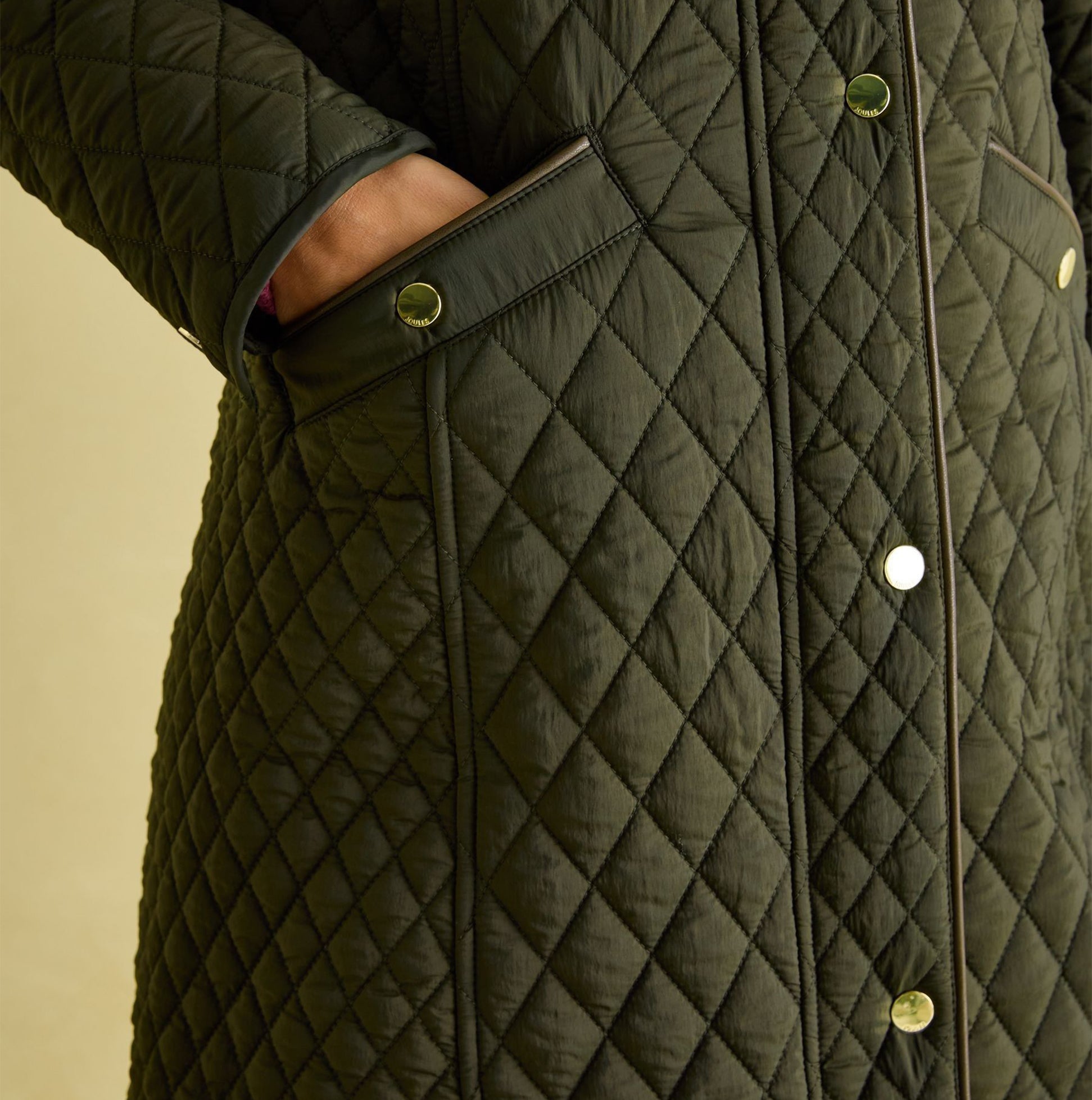 Joules ROSEWELL Womens Longline Quilted Showerproof Coat Green detail view showcasing diamond quilted pattern and side pockets.