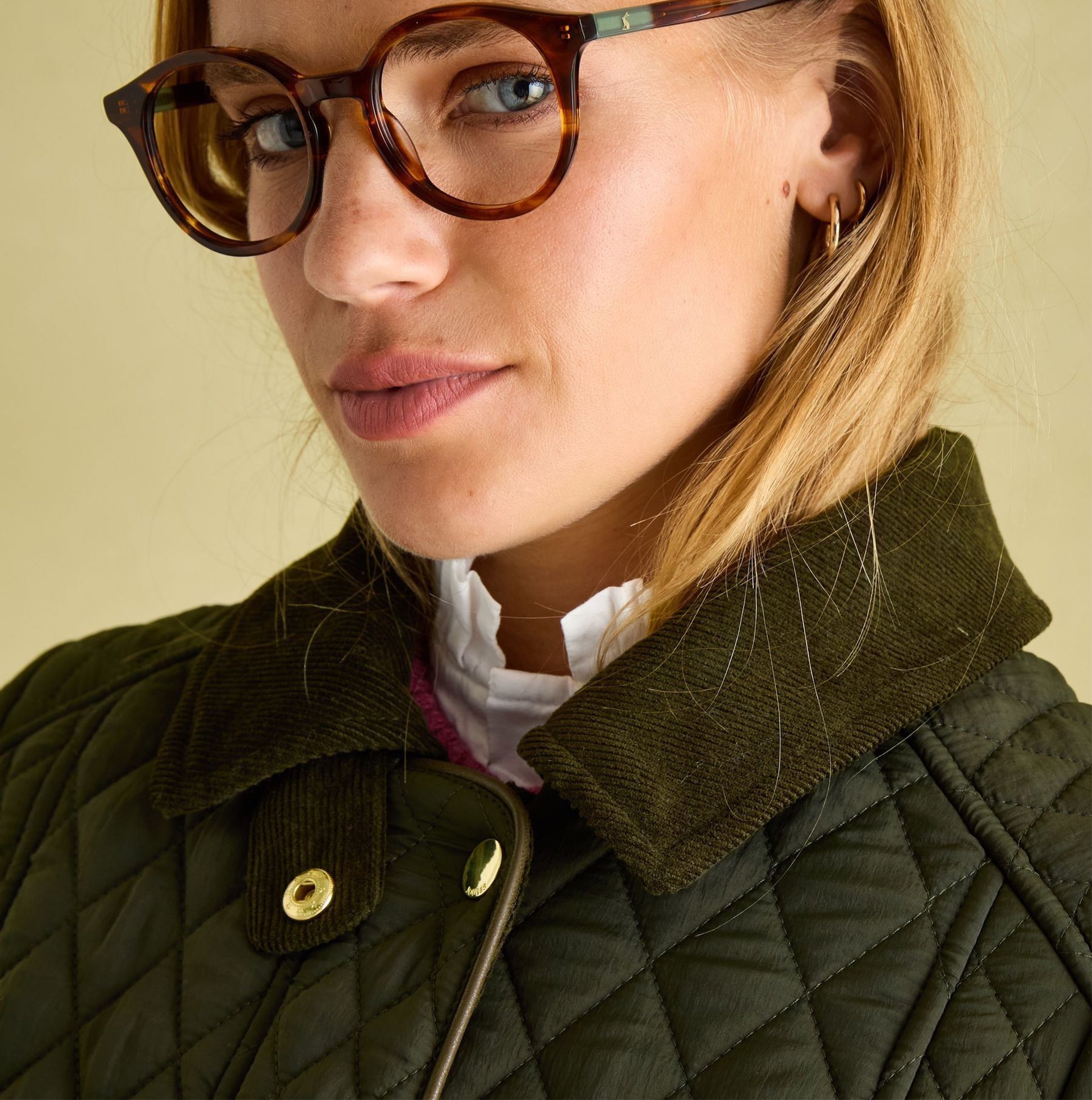 Joules ROSEWELL Womens Longline Quilted Showerproof Coat Green detail view of collar and model wearing glasses