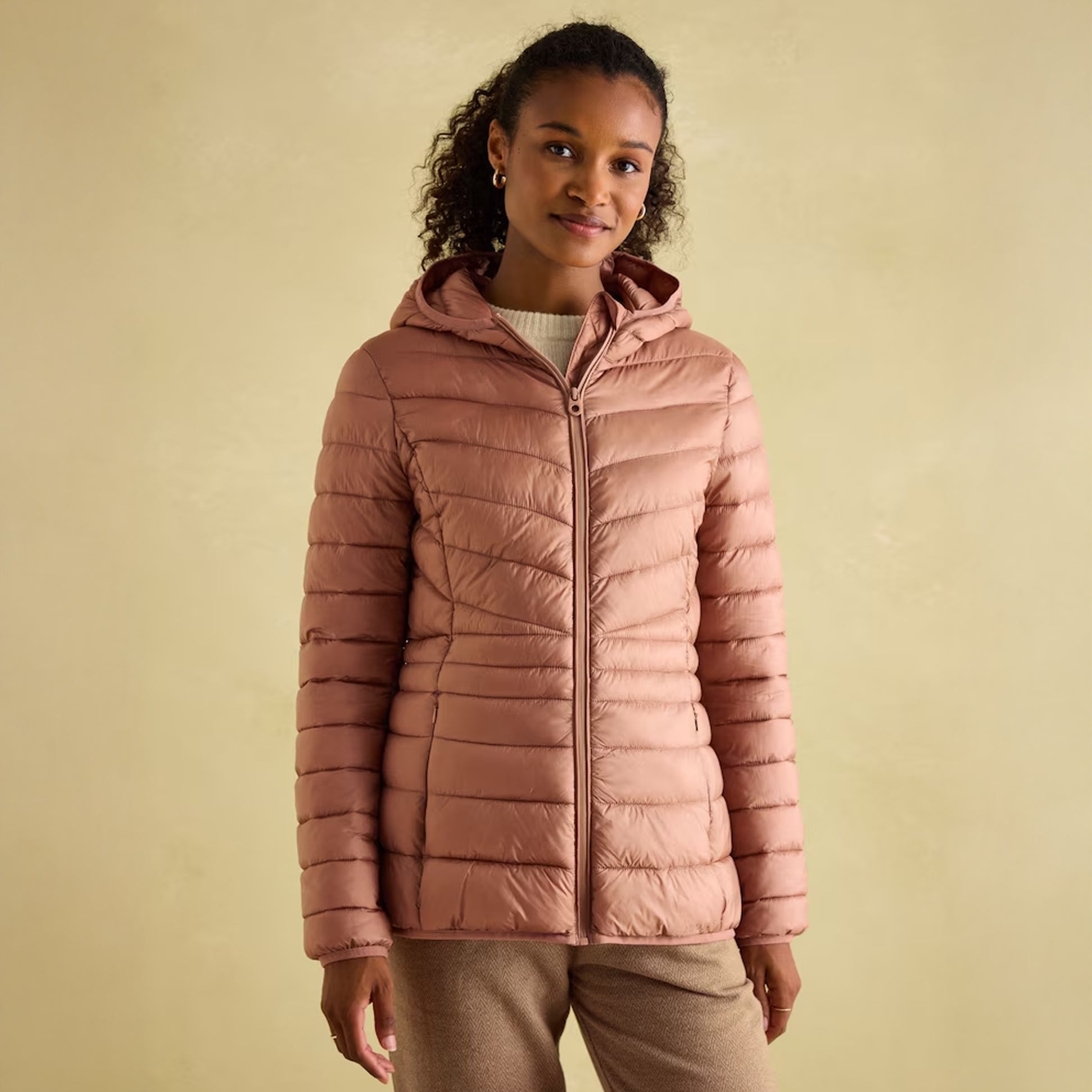 Joules KENLEY Womens Showerproof Hooded Puffer Jacket Pink front view on model with curly hair and hood up.