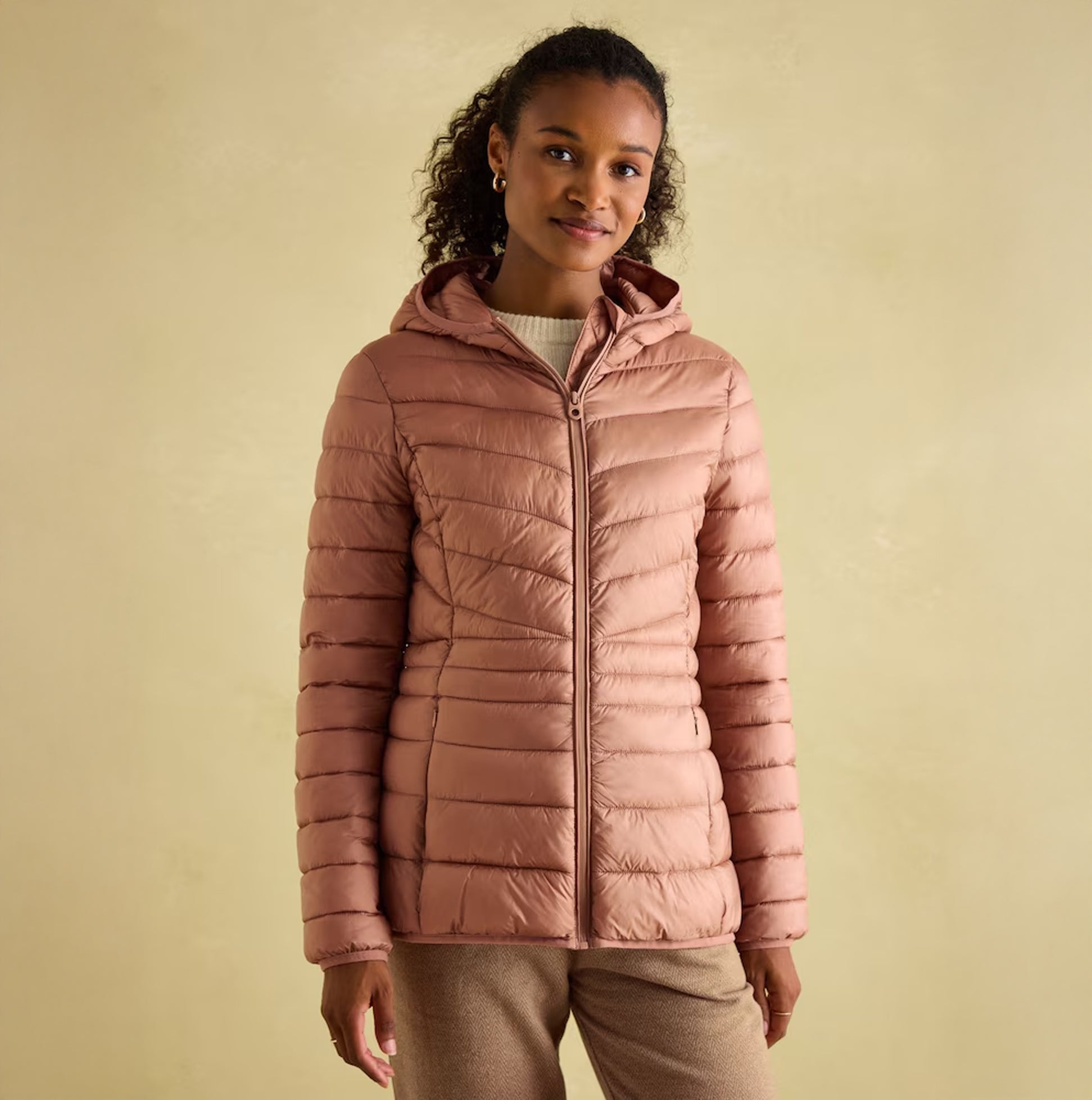 Joules KENLEY Womens Showerproof Hooded Puffer Jacket Pink front view on model with curly hair and hood up.