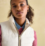 Joules BECKLEY Womens Padded Showerproof Gilet White front view featuring a model with curly hair wearing a denim shirt.