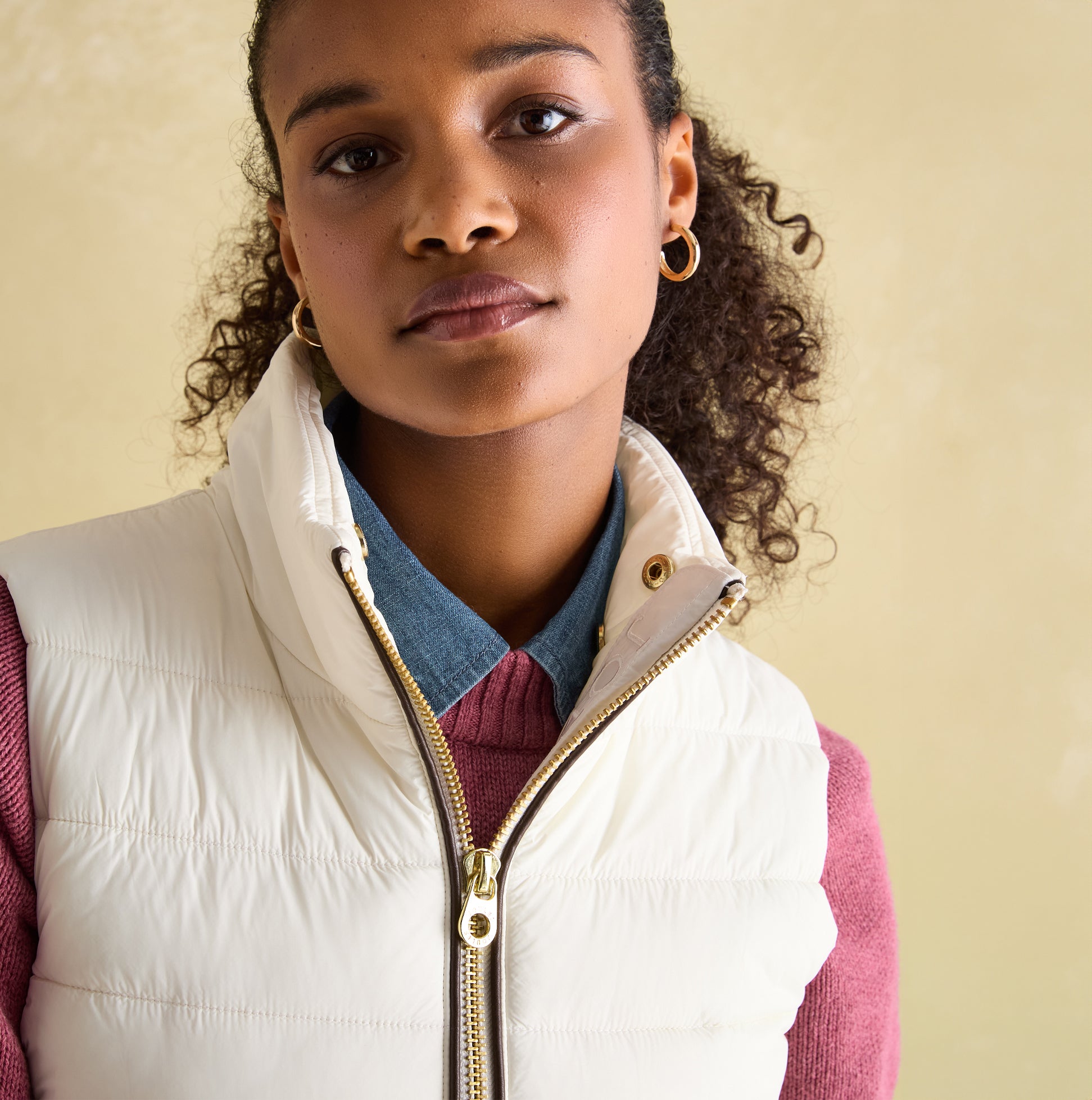 Joules BECKLEY Womens Padded Showerproof Gilet White front view featuring a model with curly hair wearing a denim shirt.