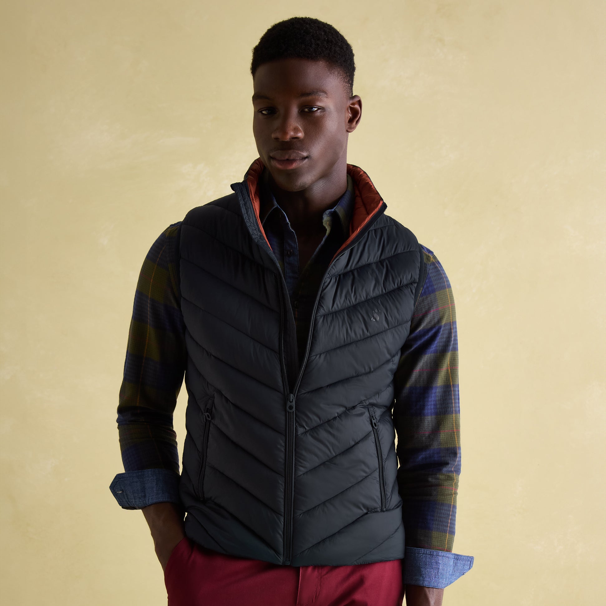 Joules GARRETT Mens Gilet Navy front view on a model, featuring zip closure and chevron quilting.