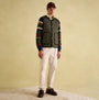 Joules GIBSON Mens Gilet Green front view styled with striped shirt and casual pants on a neutral background.