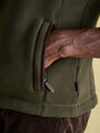 Joules GREENFIELD Mens Gilet Green close-up of hand in side pocket, showcasing zipper detail and textured fabric.