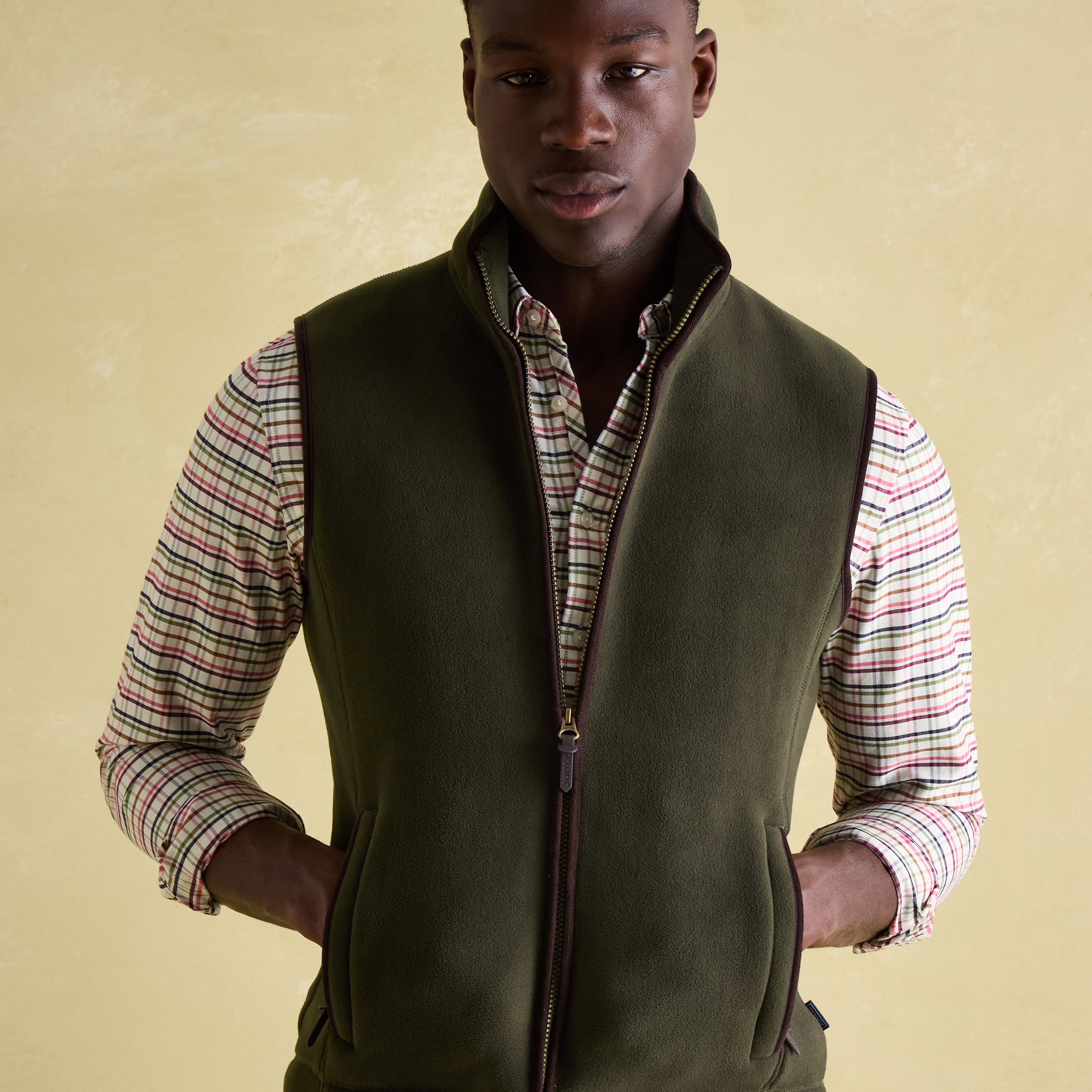 Joules GREENFIELD Mens Gilet Green front view featuring zip closure and funnel neck on model.