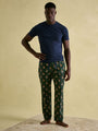 Joules DOZER Pyjama Bottoms Fenton Fox front view model wearing green pyjama bottoms with fox print, paired with a navy t-shirt.