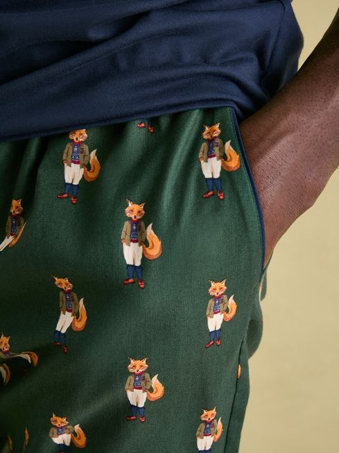 Joules DOZER Pyjama Bottoms Fenton Fox detail view showcasing fox print on green fabric with side pocket.