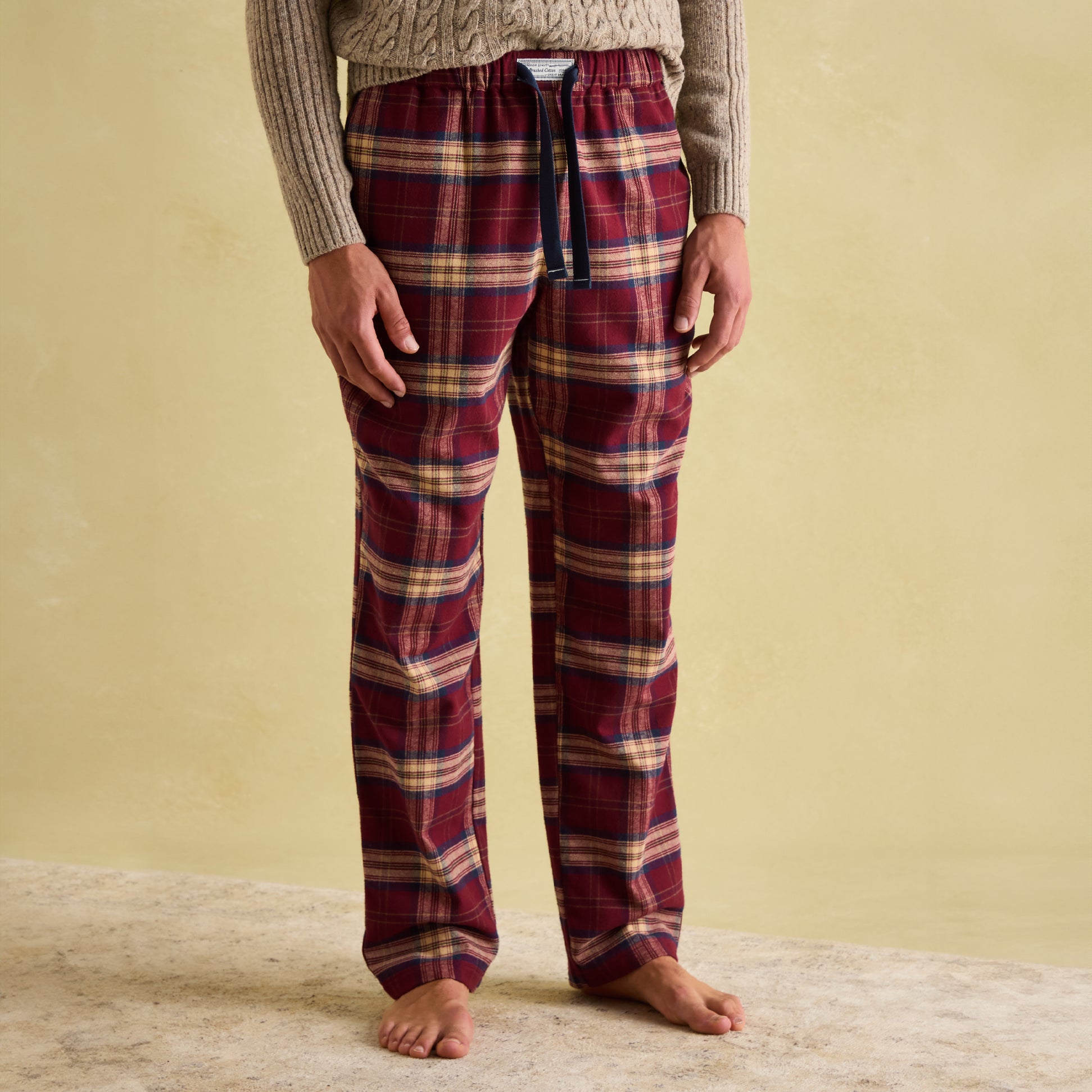 Joules SLEEPER Mens Pyjama Bottoms Red Check front view showcasing relaxed fit, drawcord waist, and checked pattern.