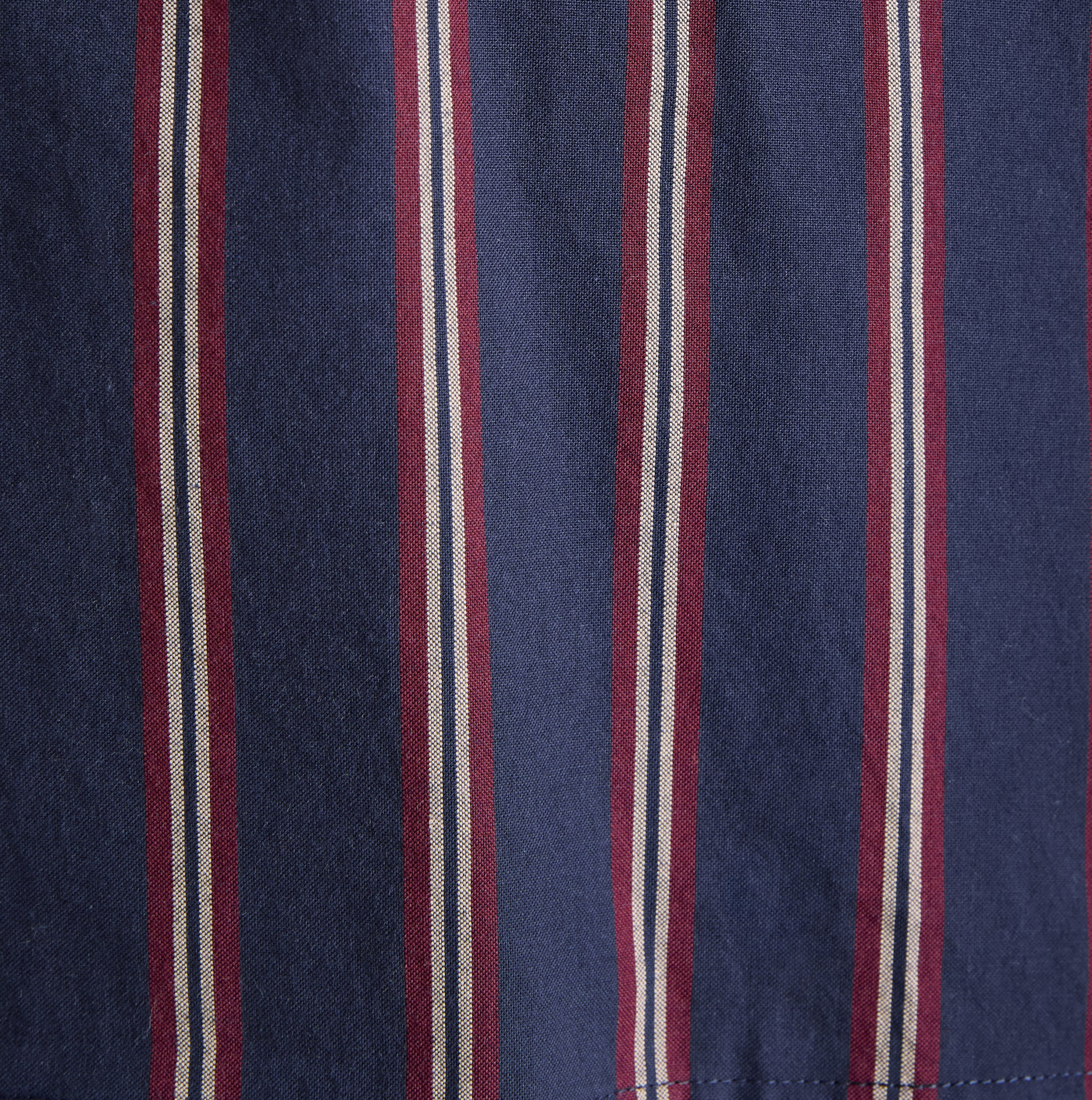 Close-up detail view of Joules HUGO Mens Pyjama Set Navy Stripe fabric showing navy and maroon stripes.