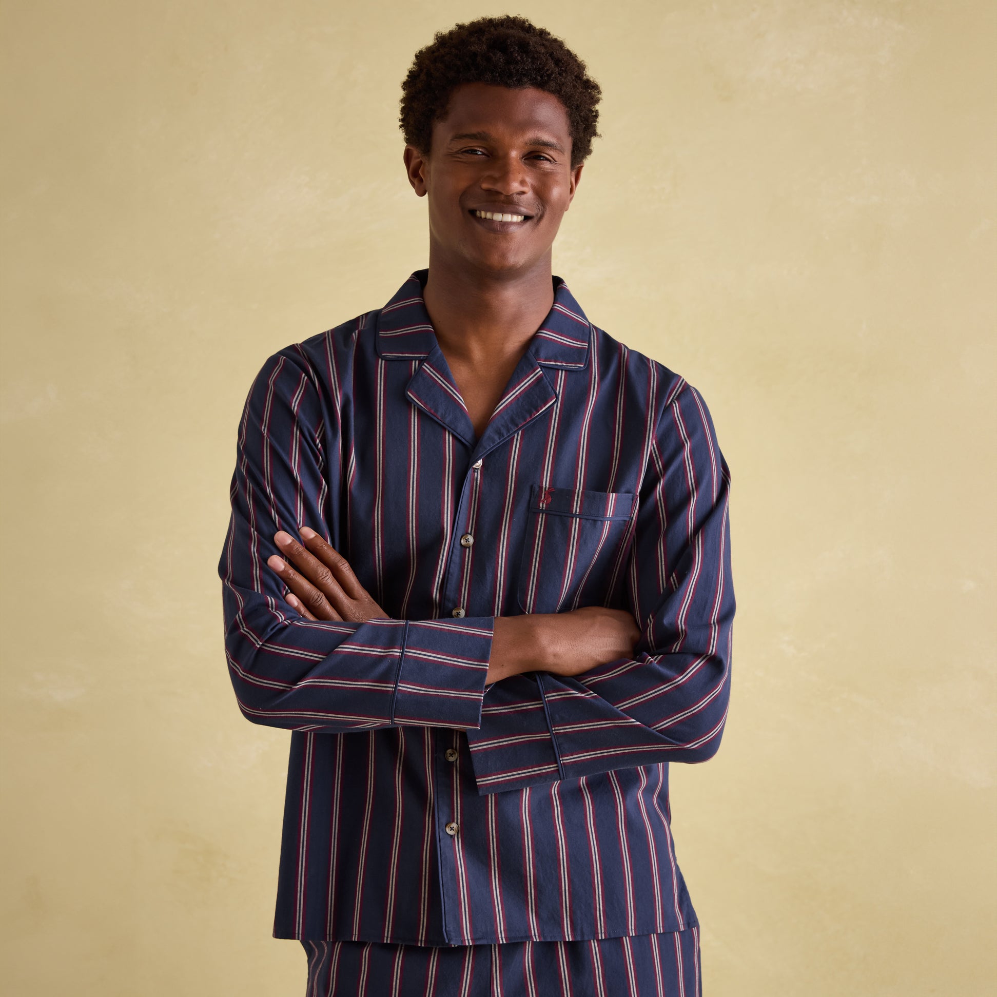 Joules HUGO Mens Pyjama Set Navy Stripe front view on model smiling, showcasing striped design and single chest pocket.