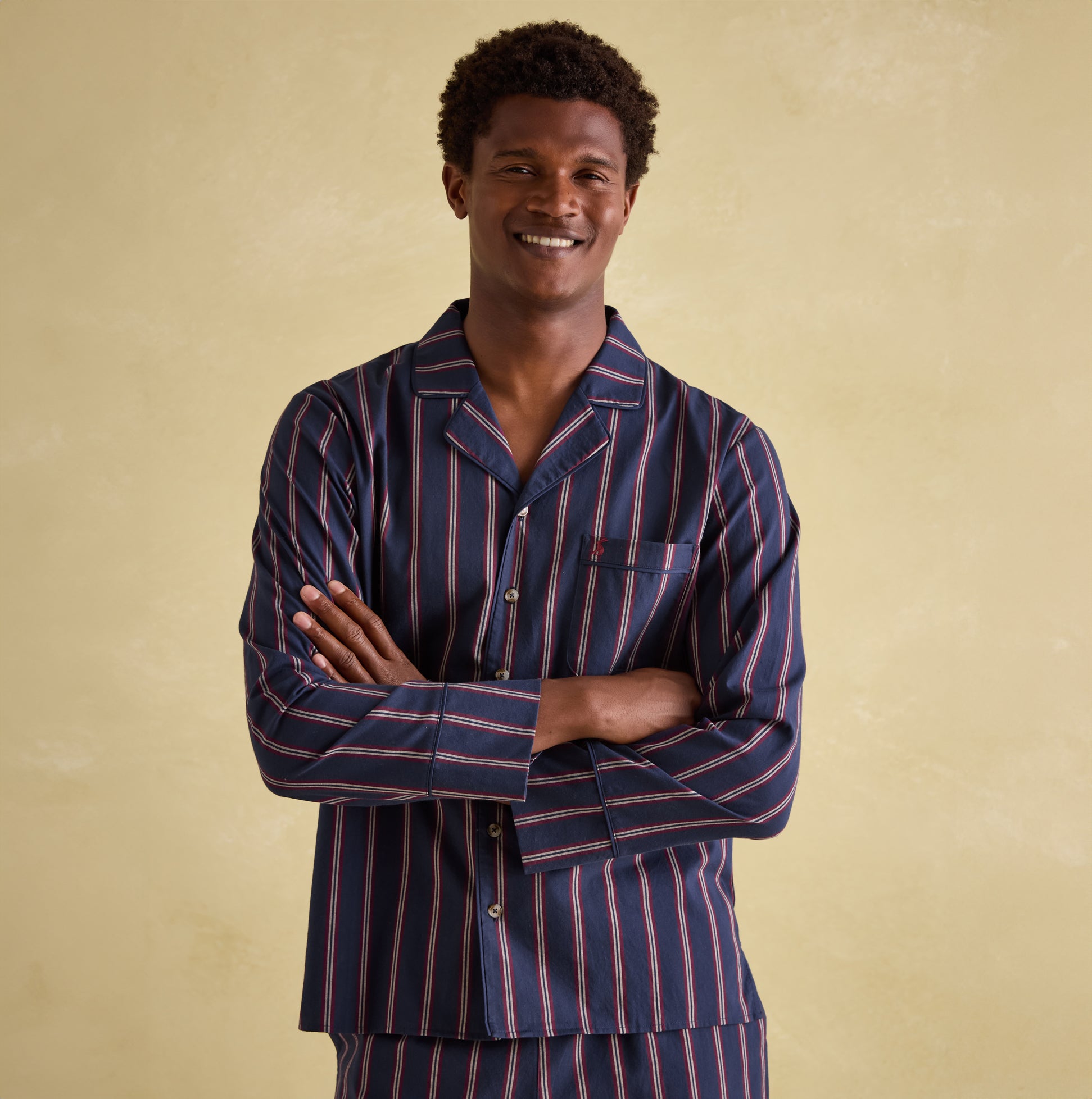 Joules HUGO Mens Pyjama Set Navy Stripe front view on model smiling, showcasing striped design and single chest pocket.