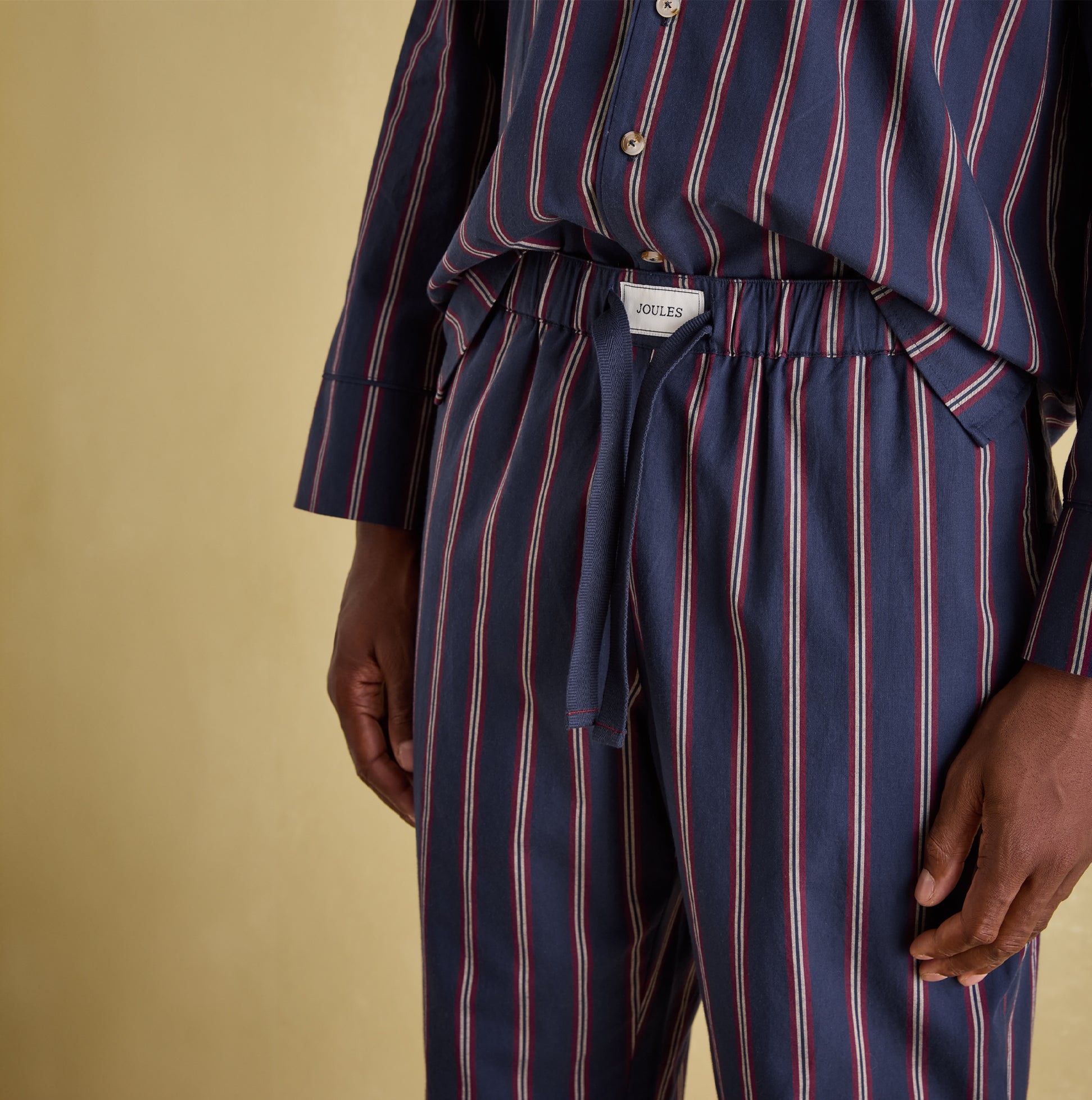 Joules HUGO Mens Pyjama Set Navy Stripe detail view, featuring elasticated waist and branded tab.