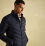 Joules GARRETT Mens Jacket Navy front view, featuring chevron quilting and zip fastening, model wearing the padded jacket.