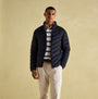 Joules GARRETT Mens Jacket Navy front view worn by a model, showcasing padded design and chevron quilting.