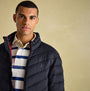 Joules GARRETT Mens Jacket Navy front view worn by model, featuring padded design and zip closure.