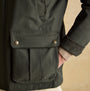 Joules FARLEIGH Mens Waterproof Midweight Country Coat Green side view showing pocket detail and fabric texture.