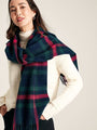 Joules LANGTREE Womens Scarf Navy Pink Check draped around model's shoulders, showcasing its woven texture and tasselled ends.
