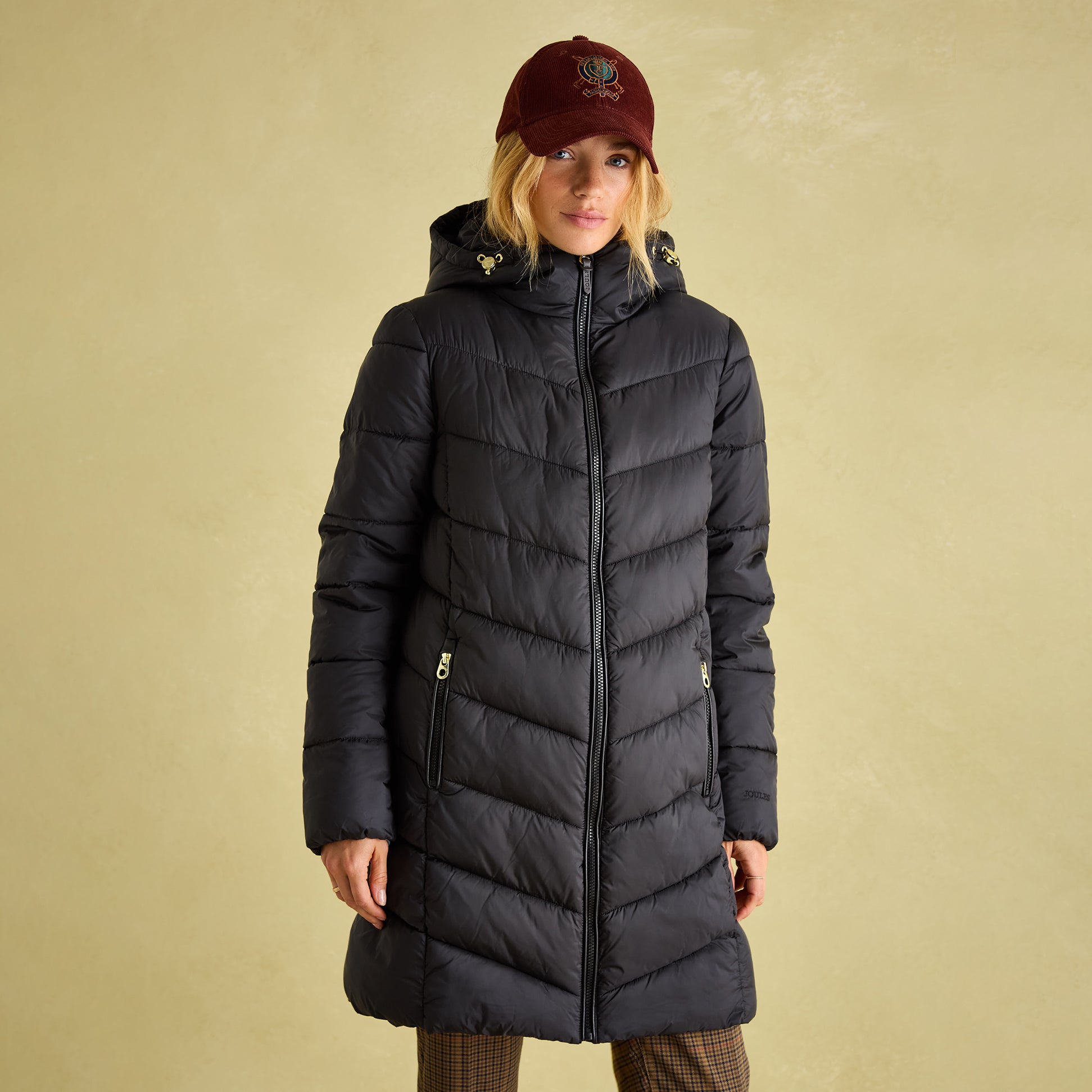 Joules MOORSDALE Womens Mid Length Showerproof Padded Coat with Hood Black front view, model wearing coat with hat.