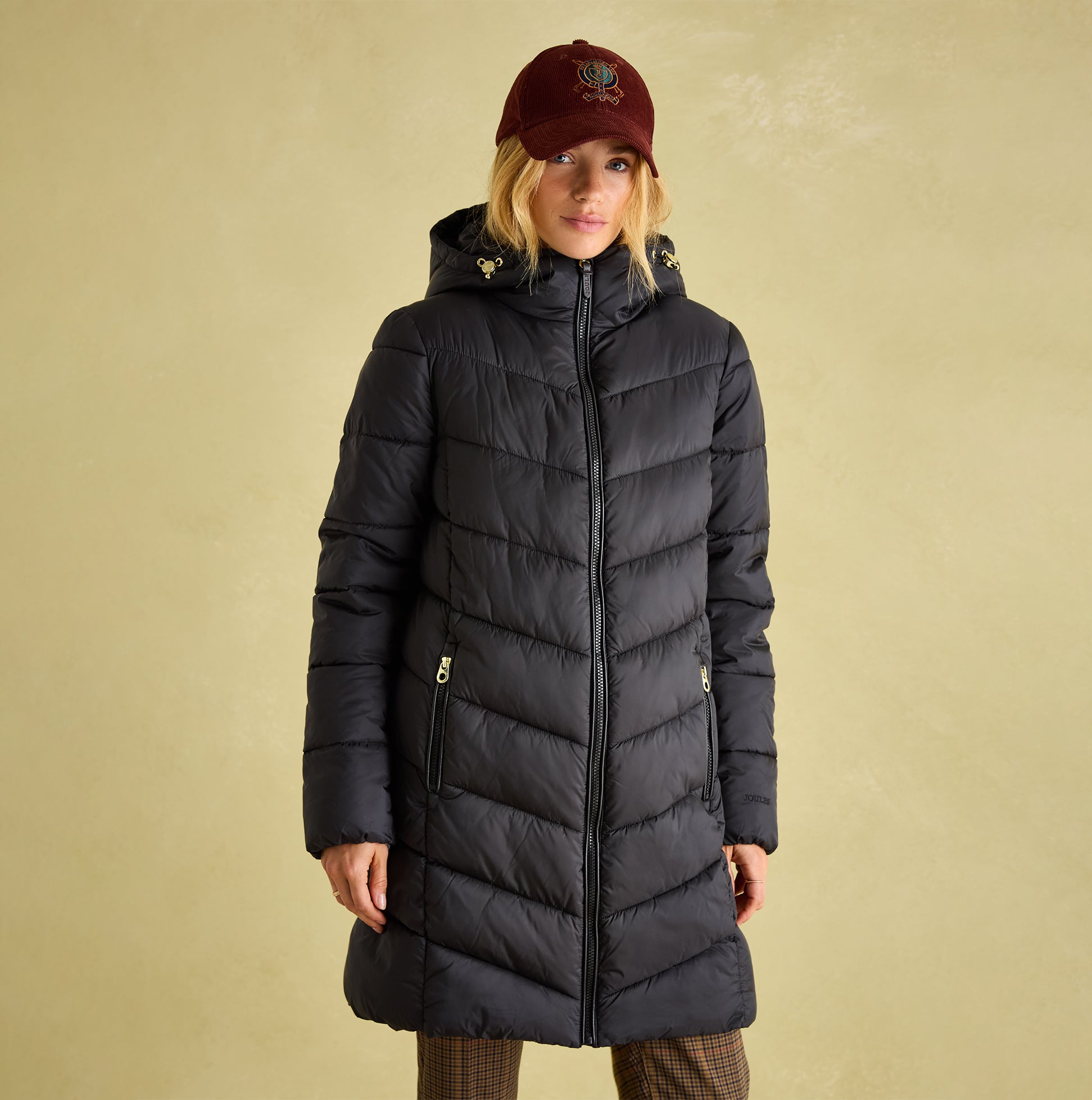Joules MOORSDALE Womens Mid Length Showerproof Padded Coat with Hood Black front view, model wearing coat with hat.