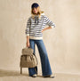 Joules CAMBECK NYLON RUCKSACK Womens NEUTRAL side view on model, styled with striped hoodie and flared jeans.