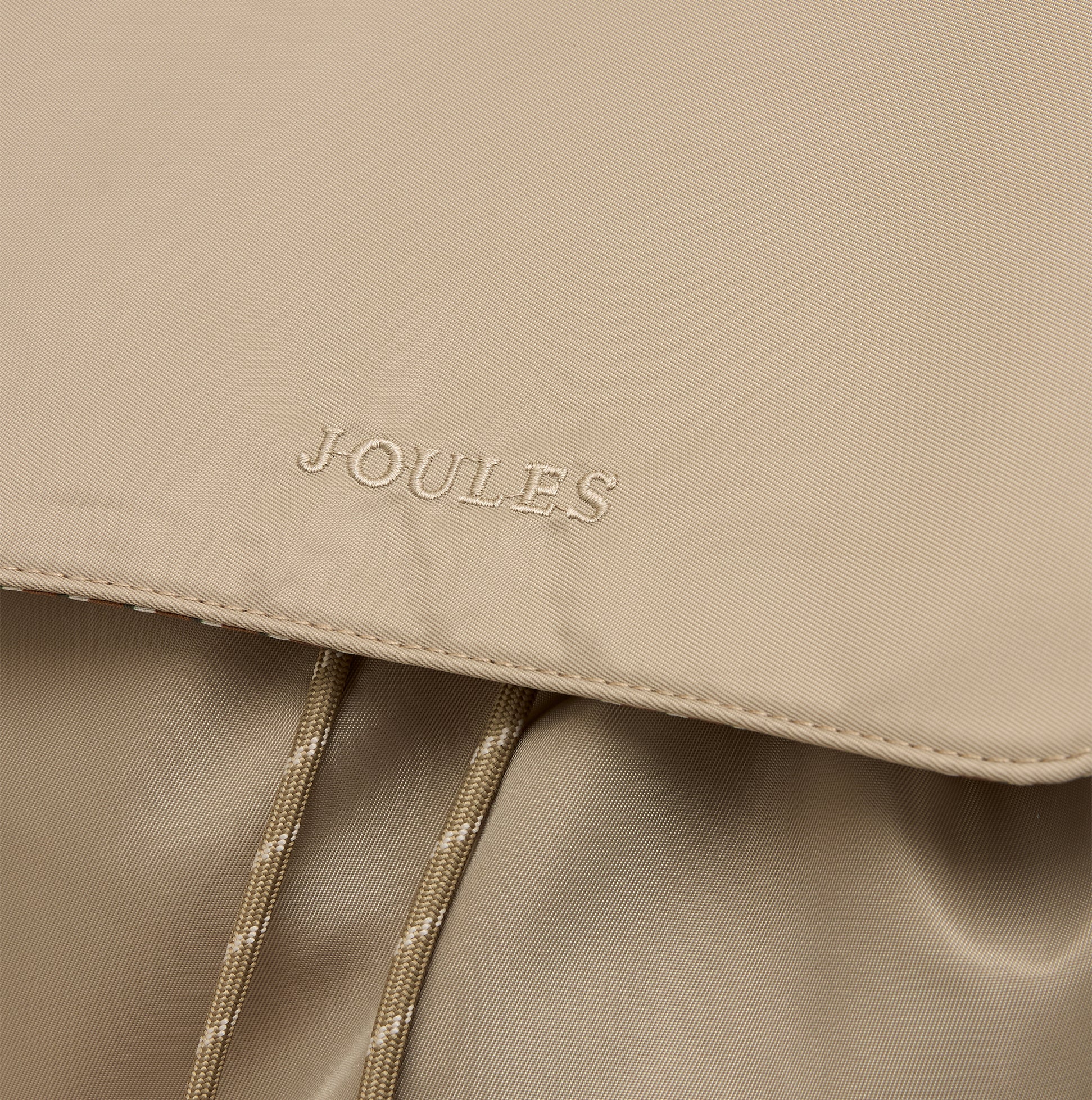 Joules CAMBECK NYLON RUCKSACK Womens NEUTRAL close-up view of logo on beige fabric.