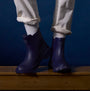 Joules RAINDANCE Lightweight Wellies Navy side view on a person standing on wooden surface with light clothing.