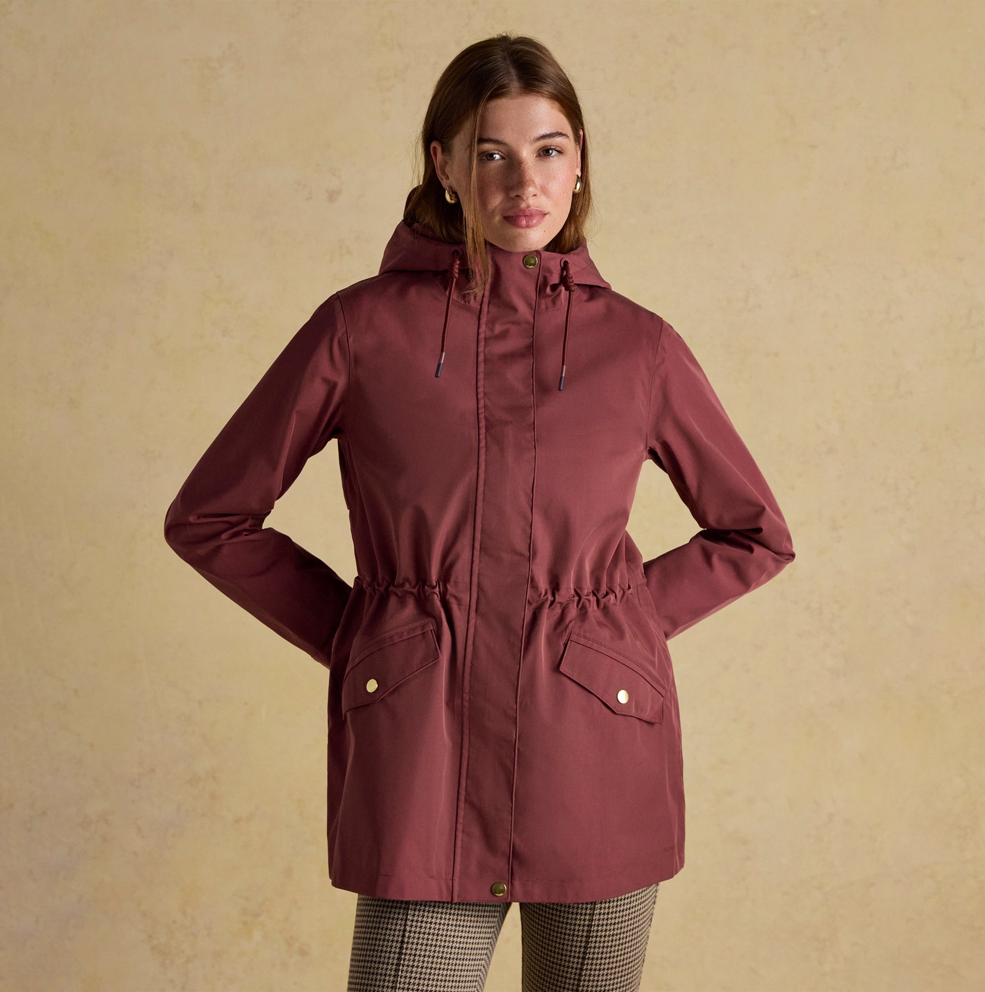 Joules PORTWELL Waterproof Hoodie Raincoat With Adjustable Waist Oxblood front view, showcasing hood and adjustable waist.