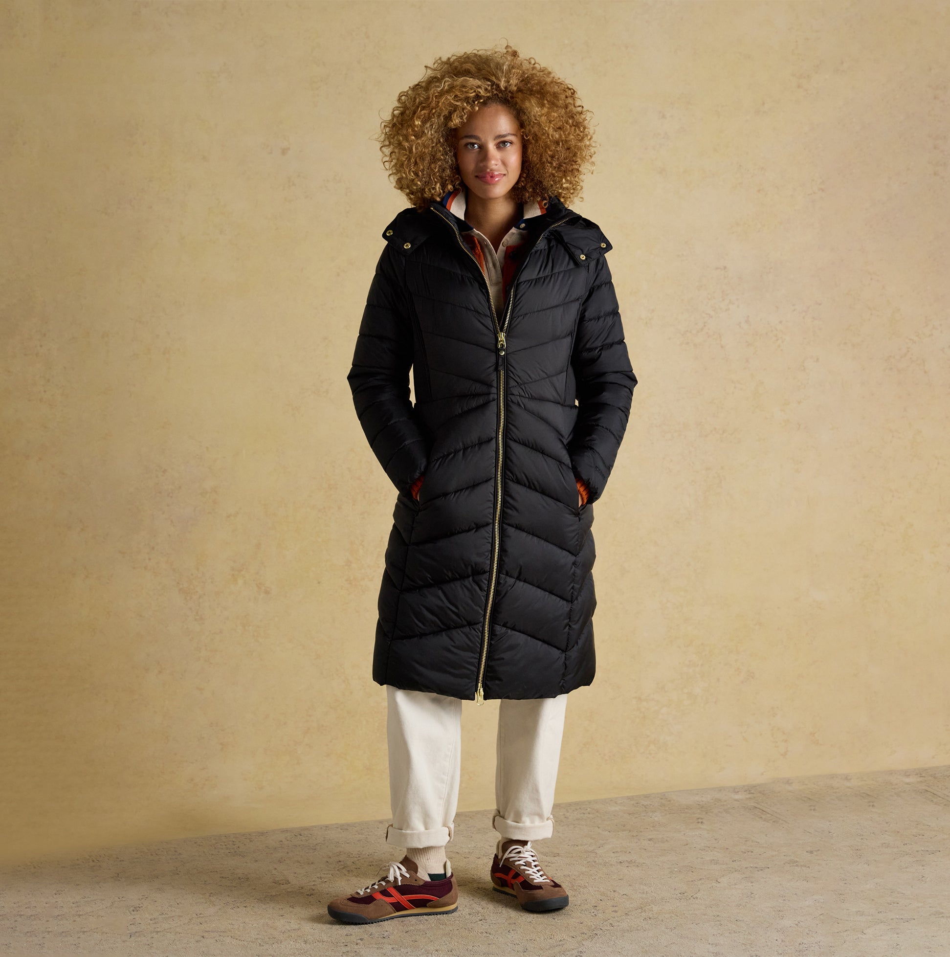 Joules PEMBURY Womens Showerproof Longline Padded Coat with Hood Black front view on model with curly hair