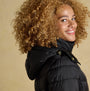 Joules PEMBURY Womens Showerproof Longline Padded Coat with Hood Black side view showing model smiling and wearing coat